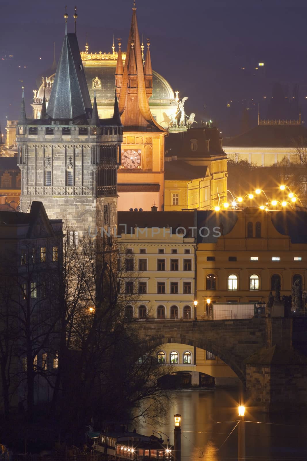 czech republic, prague - towers of the old town and national theatre at dusk