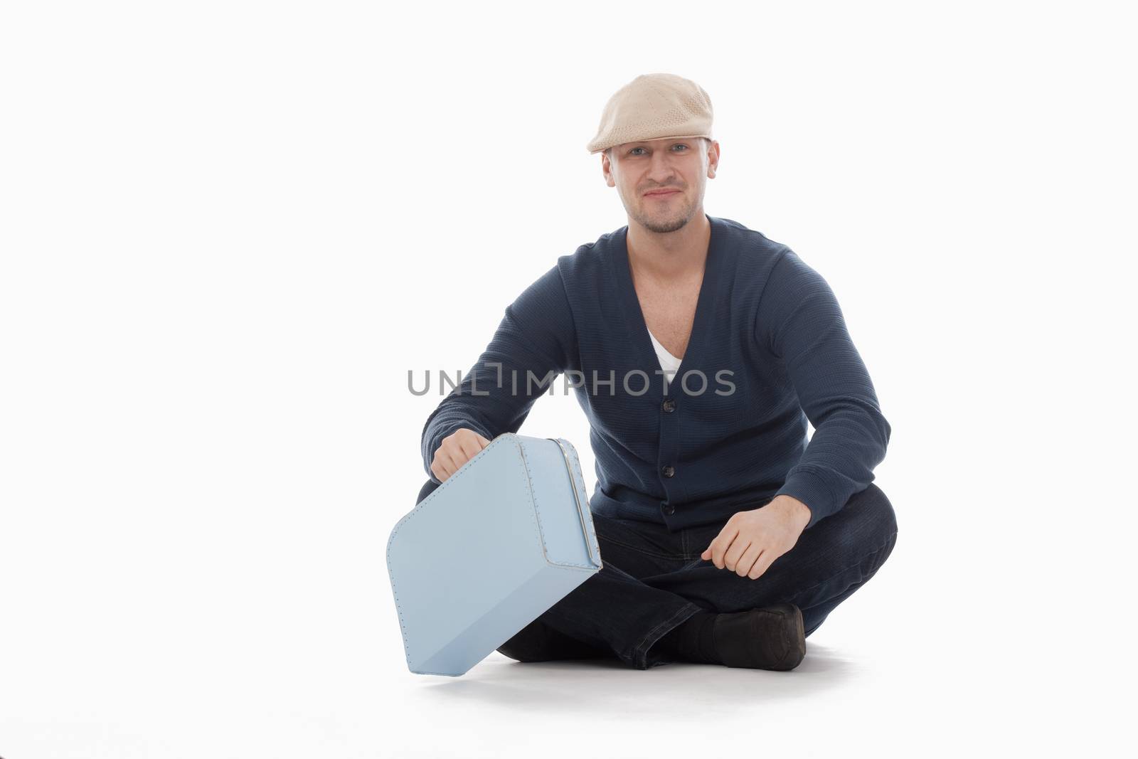 man with a cap and a toy suitcase isolated on white