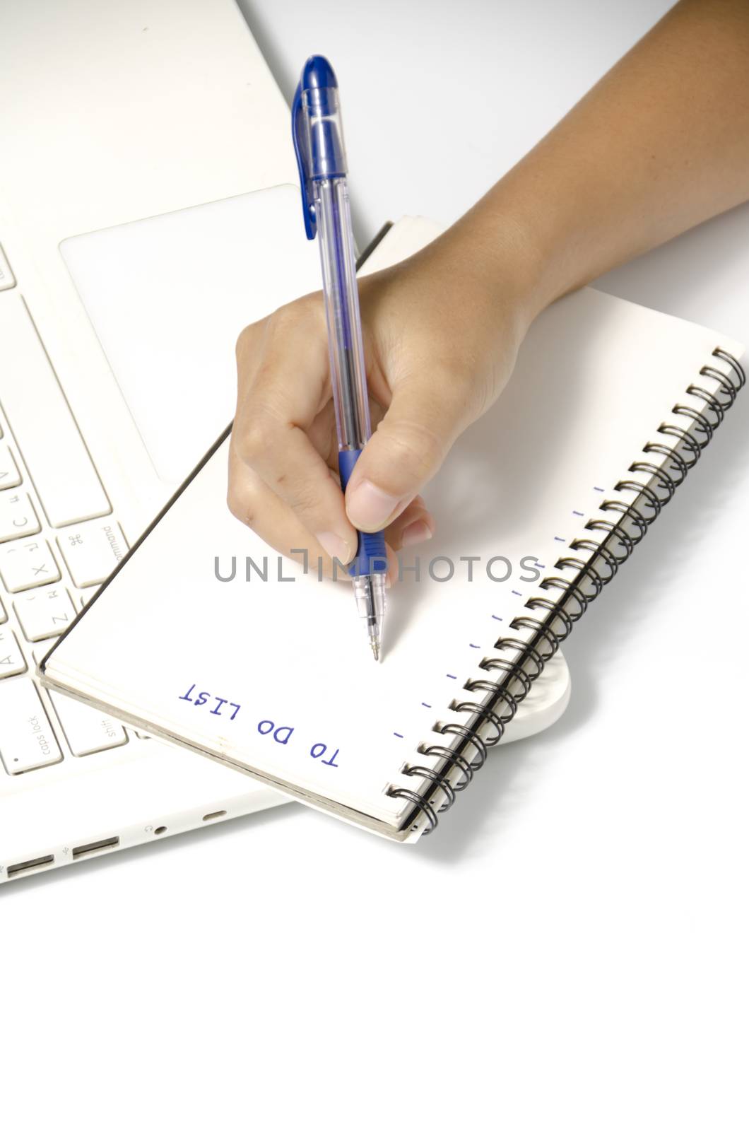 woman hand writing with pen on notebook by ammza12