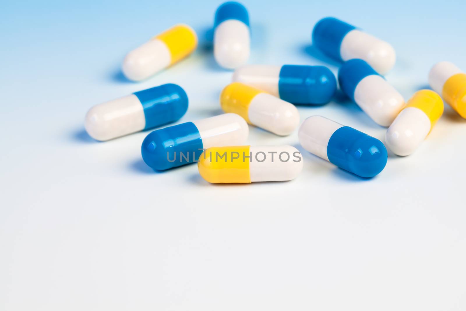 Colorful medical capsules on white background.