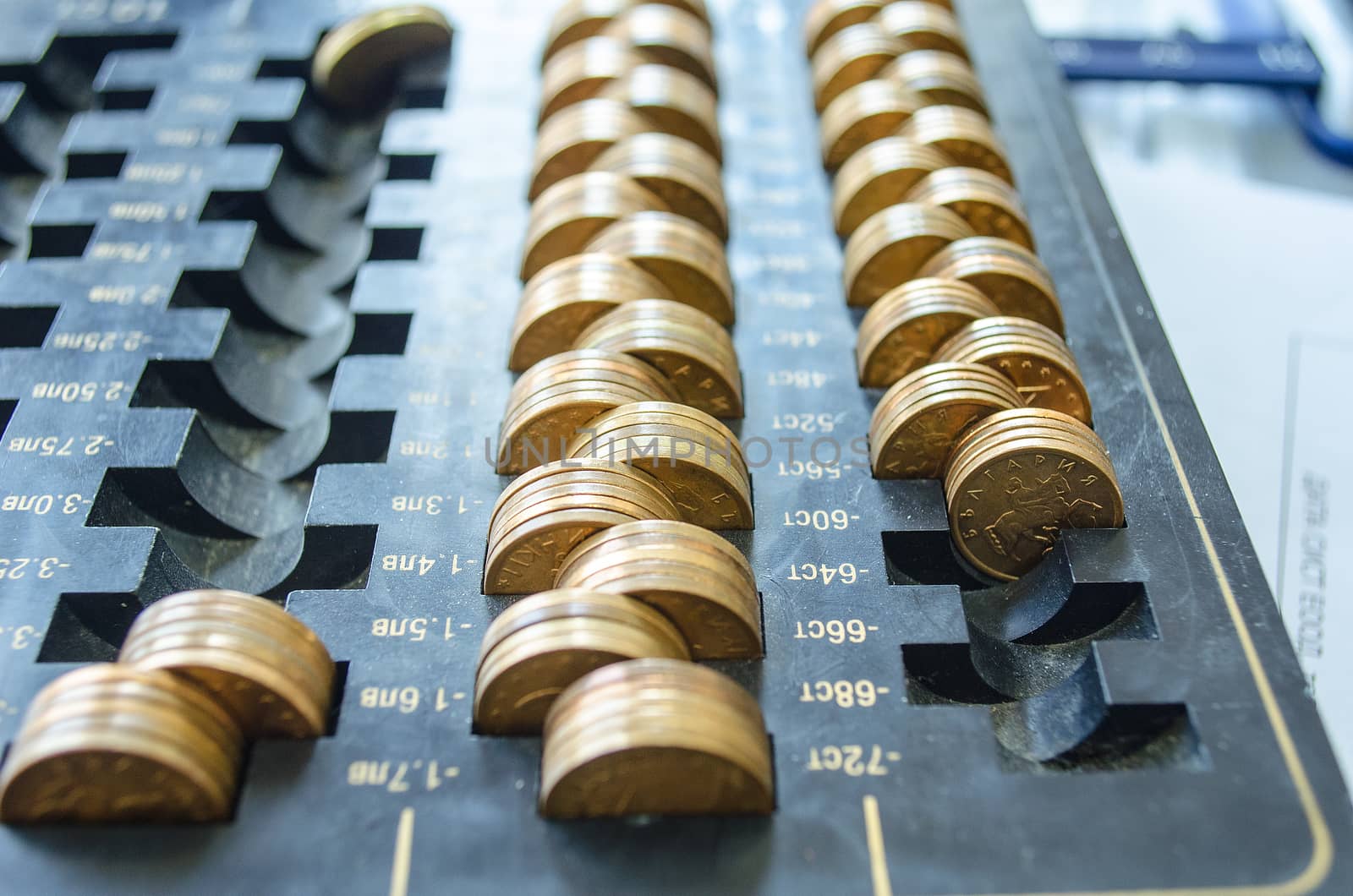 Golden coins on a black dust tray