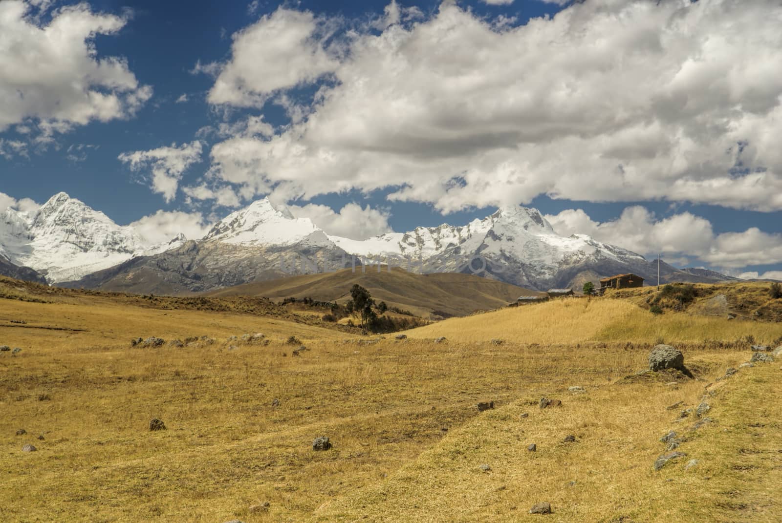 Clouds passing over sunlit meadows of Cordillera Negra in Peru