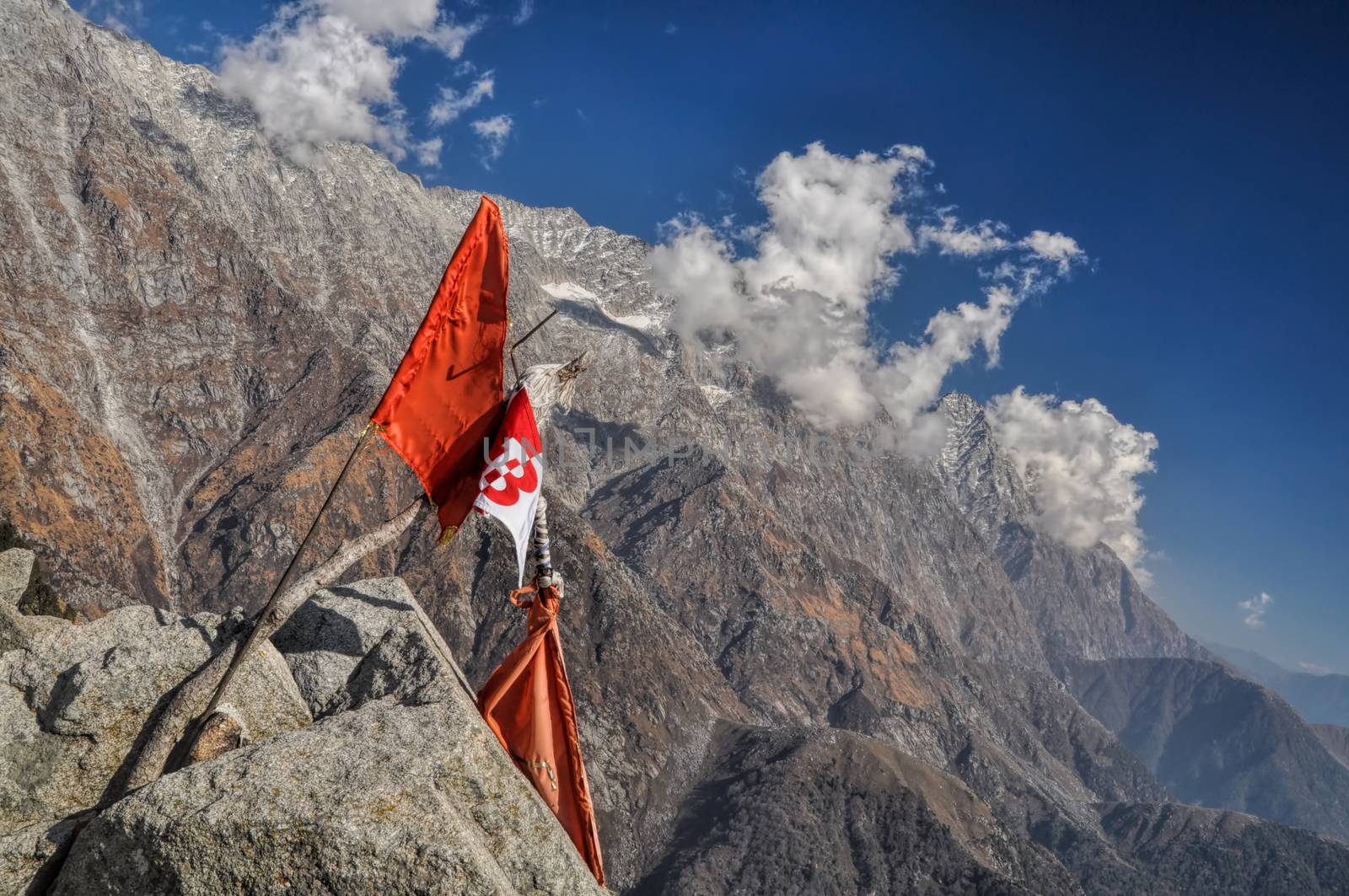 Picturesque view of a flag stuck high in the rocky slope