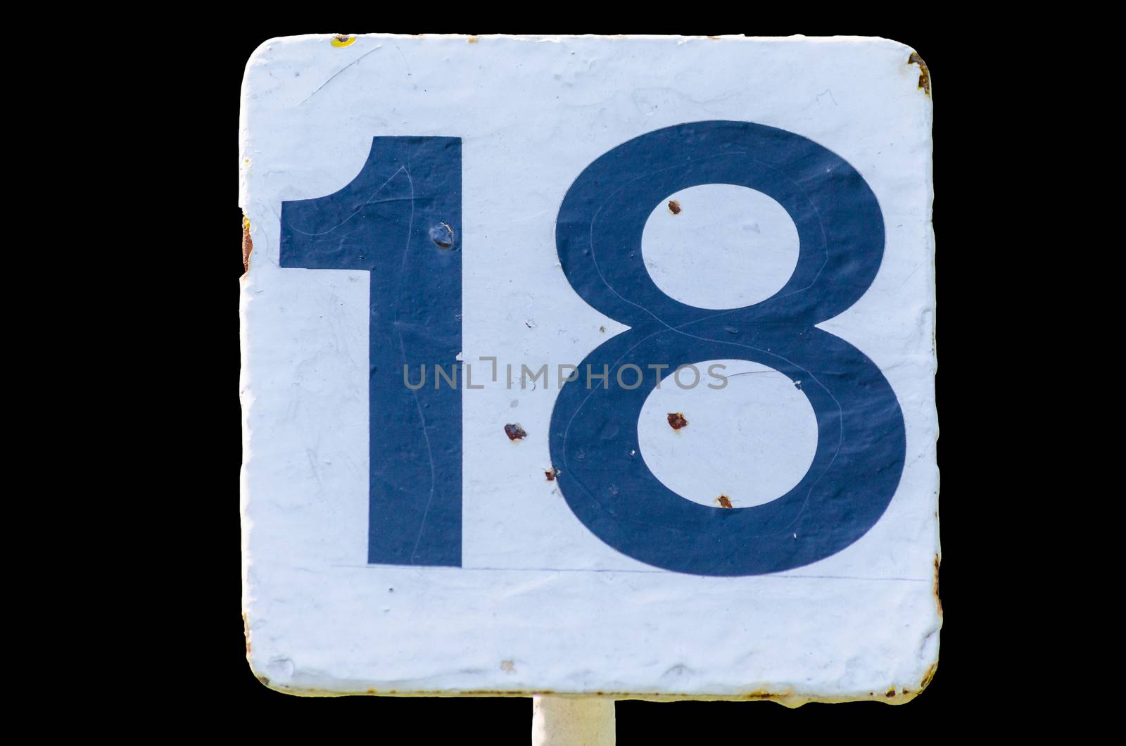 Old dirty white sign with the number 18 number on black background