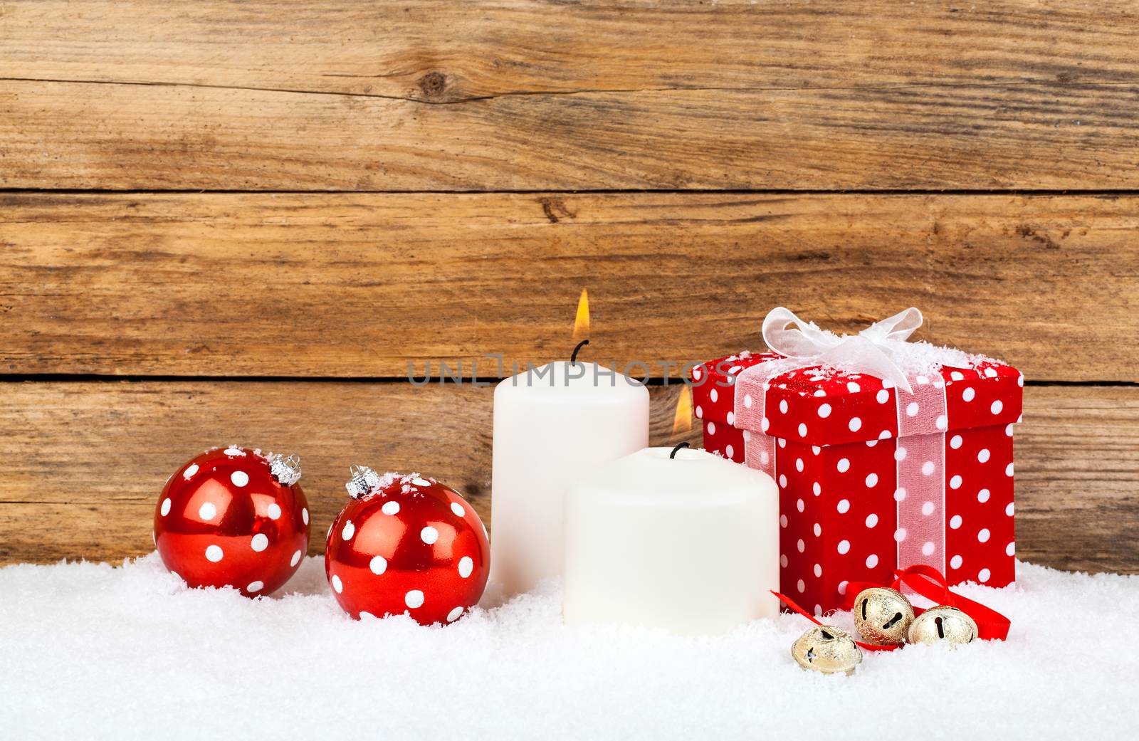 christmas red gift with snow, on wooden background