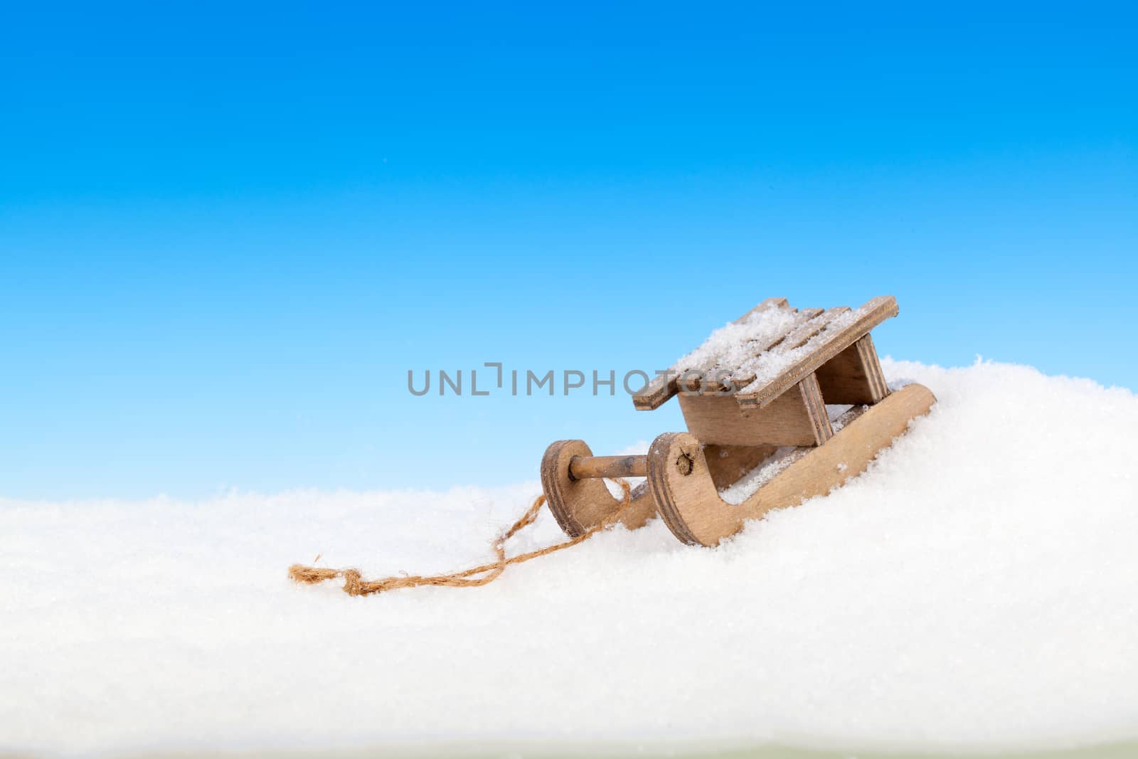 Old vintage wooden sled on blue background