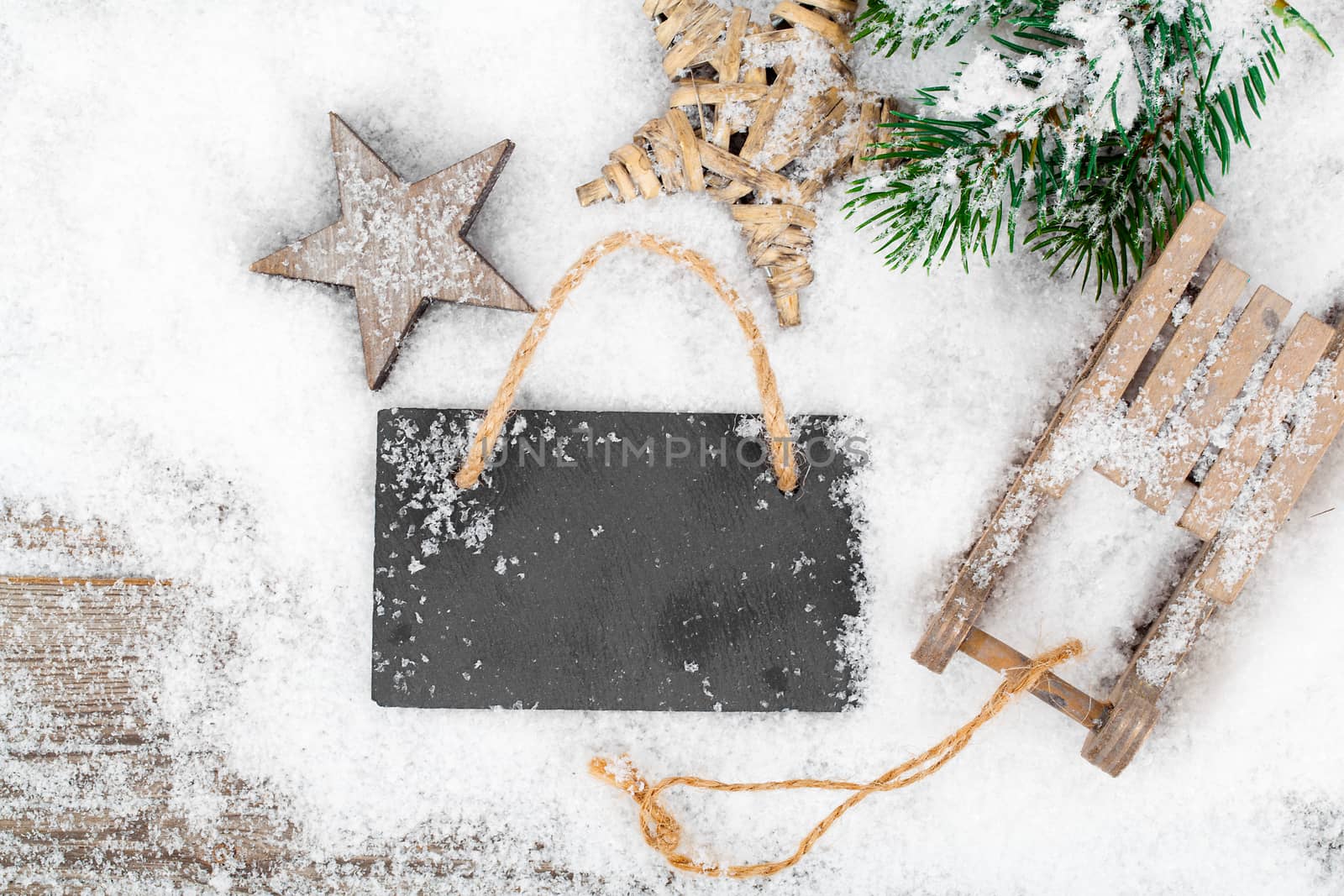 Christmas decoration over snow, wooden background