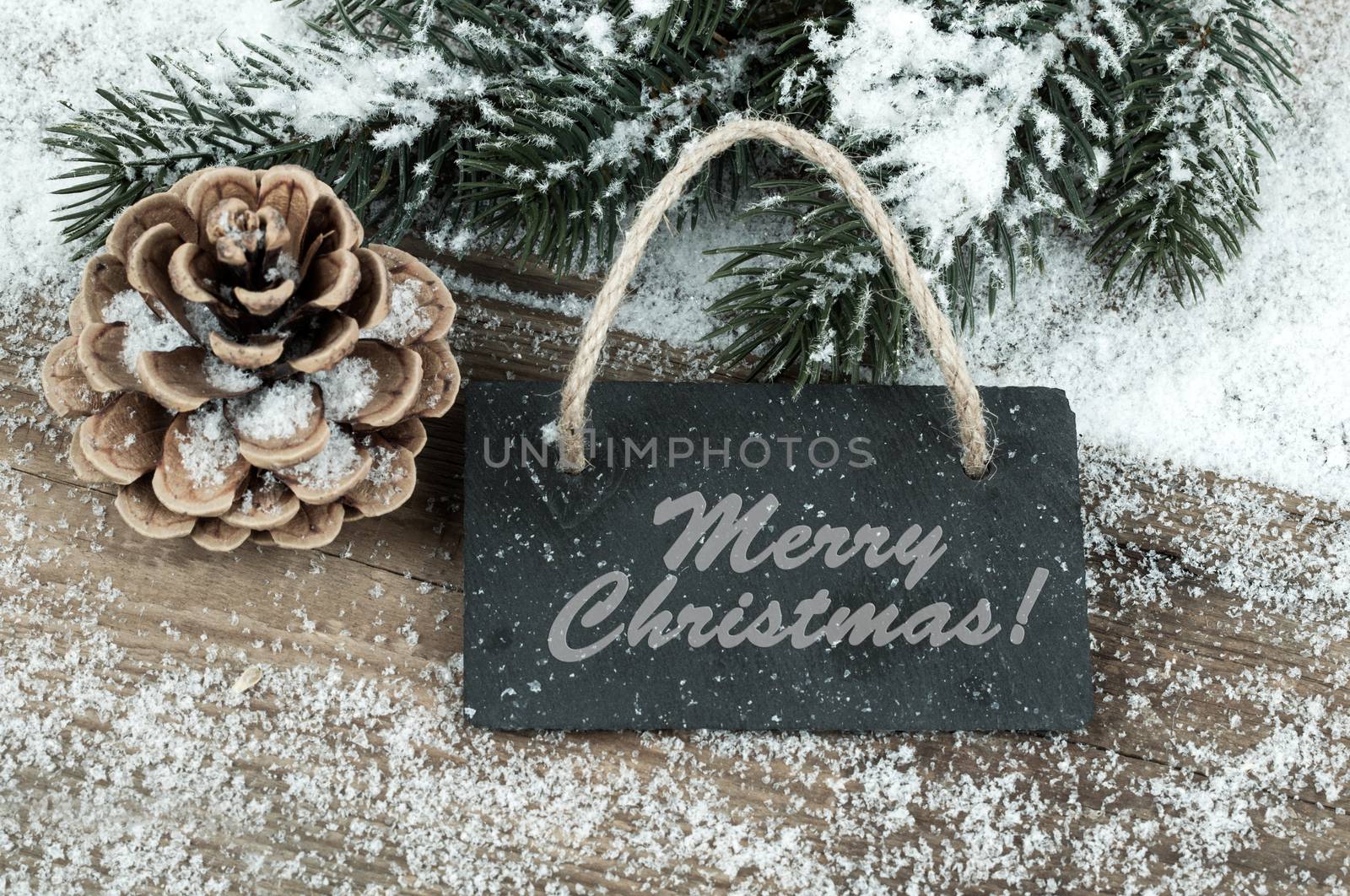 Black board of slate on old rustic wooden background, with snow