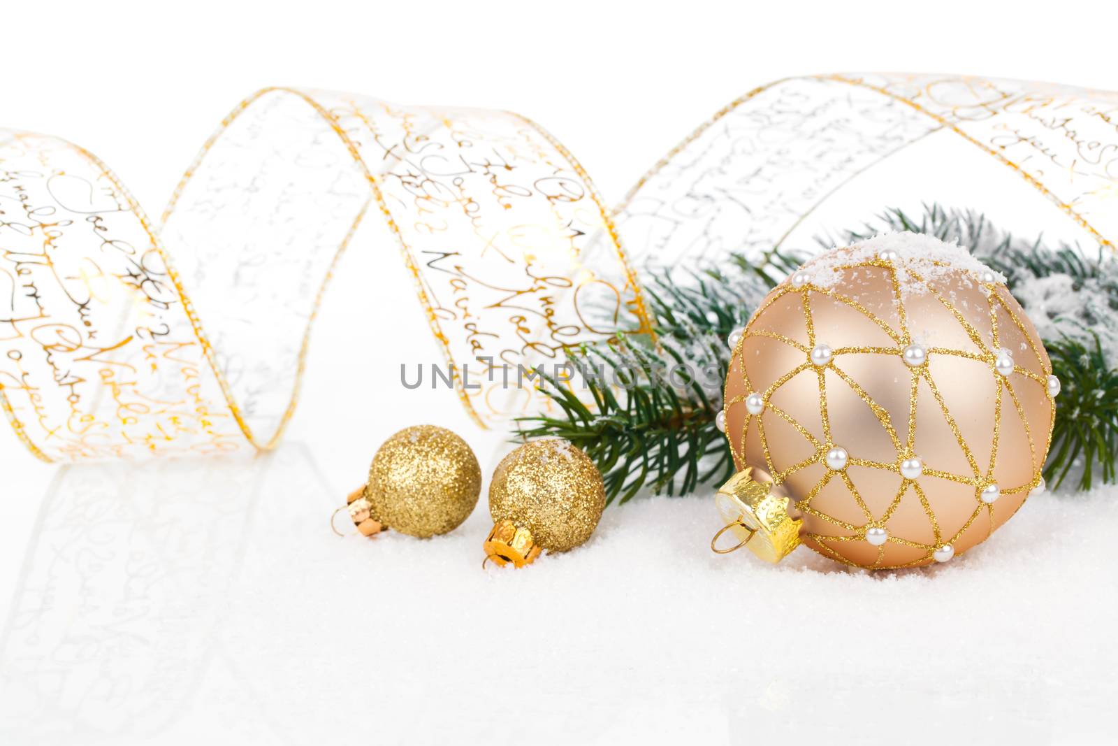 Christmas balls with ribbon on snow