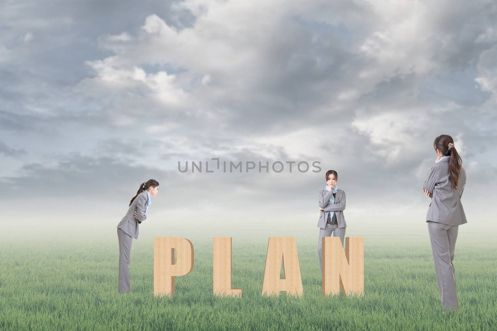 Concept of strategy, plan, idea etc with 3d wooden text and businesswoman under copyspace sky. The Asian woman is the same one.