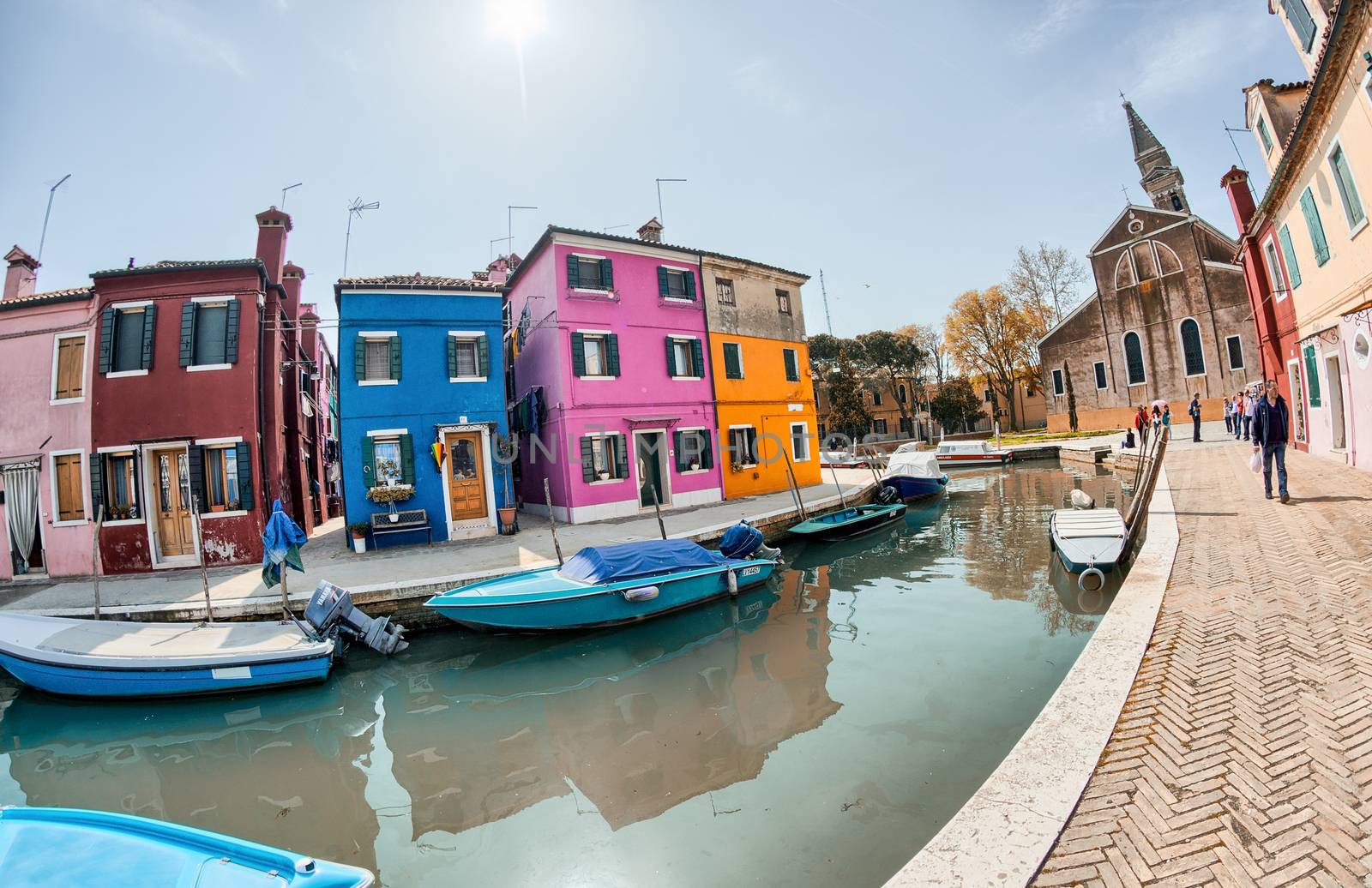 BURANO, ITALY - APRIL 8, 2014: Tourists enjoy colourful city bui by jovannig