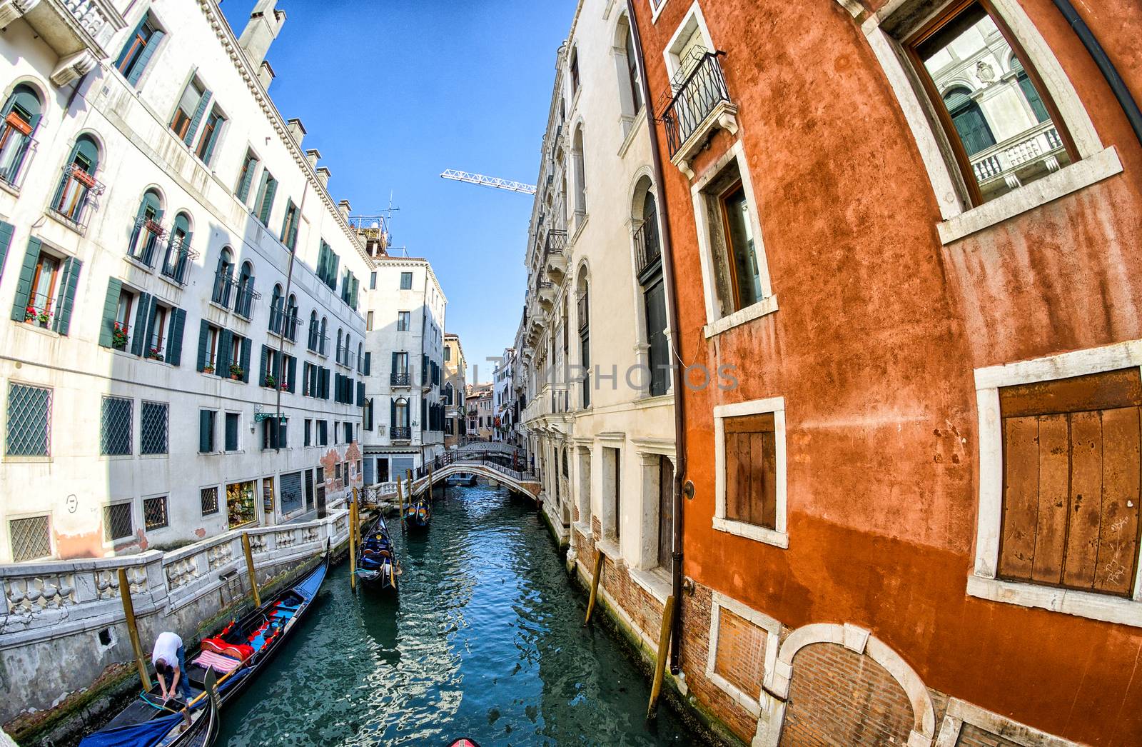 VENICE - APRIL 7, 2014: Tourists enjoy city canals on a beautifu by jovannig