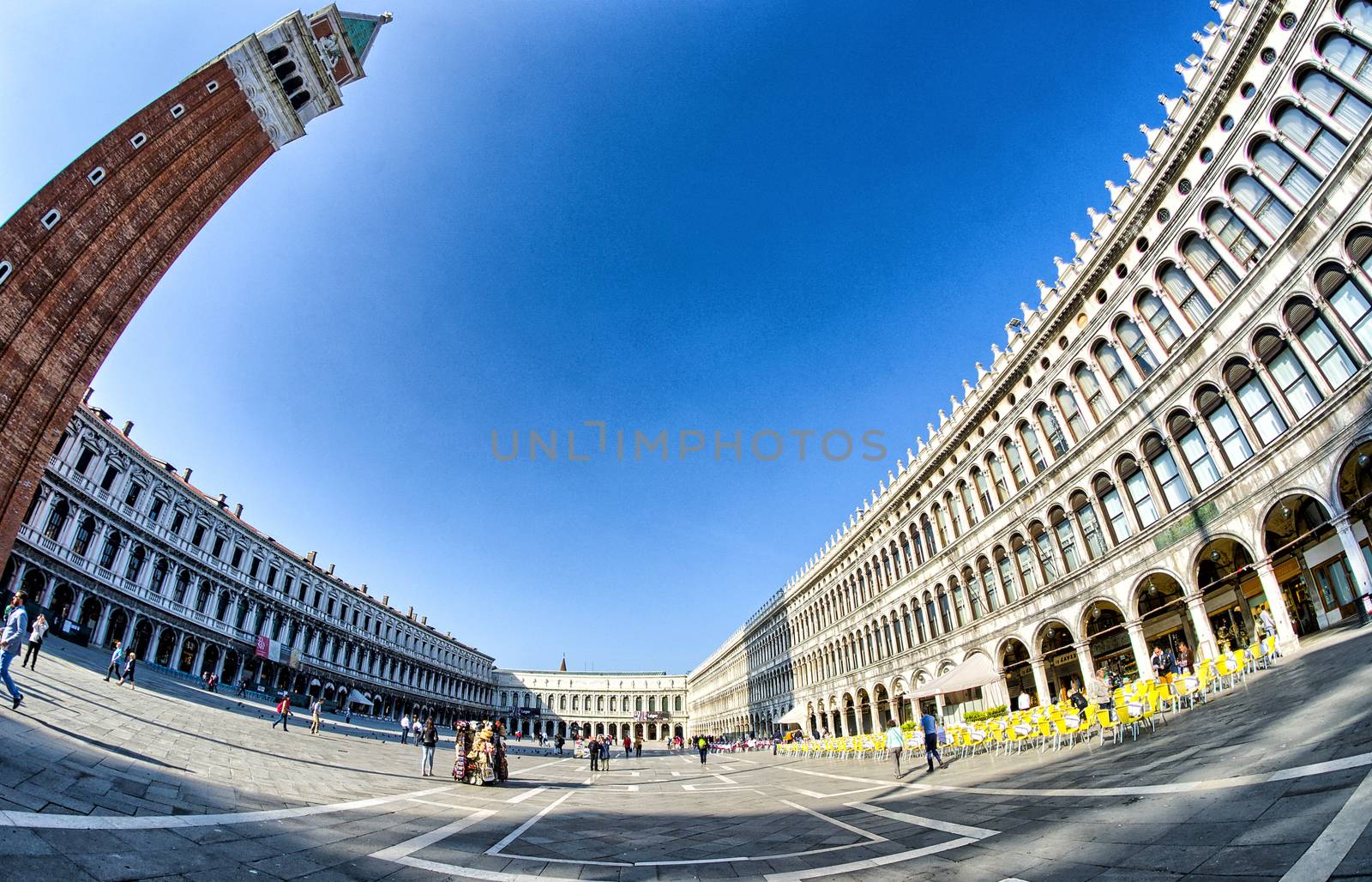 VENICE - APRIL 7, 2014: Tourists enjoy Saint Mark Square on a be by jovannig