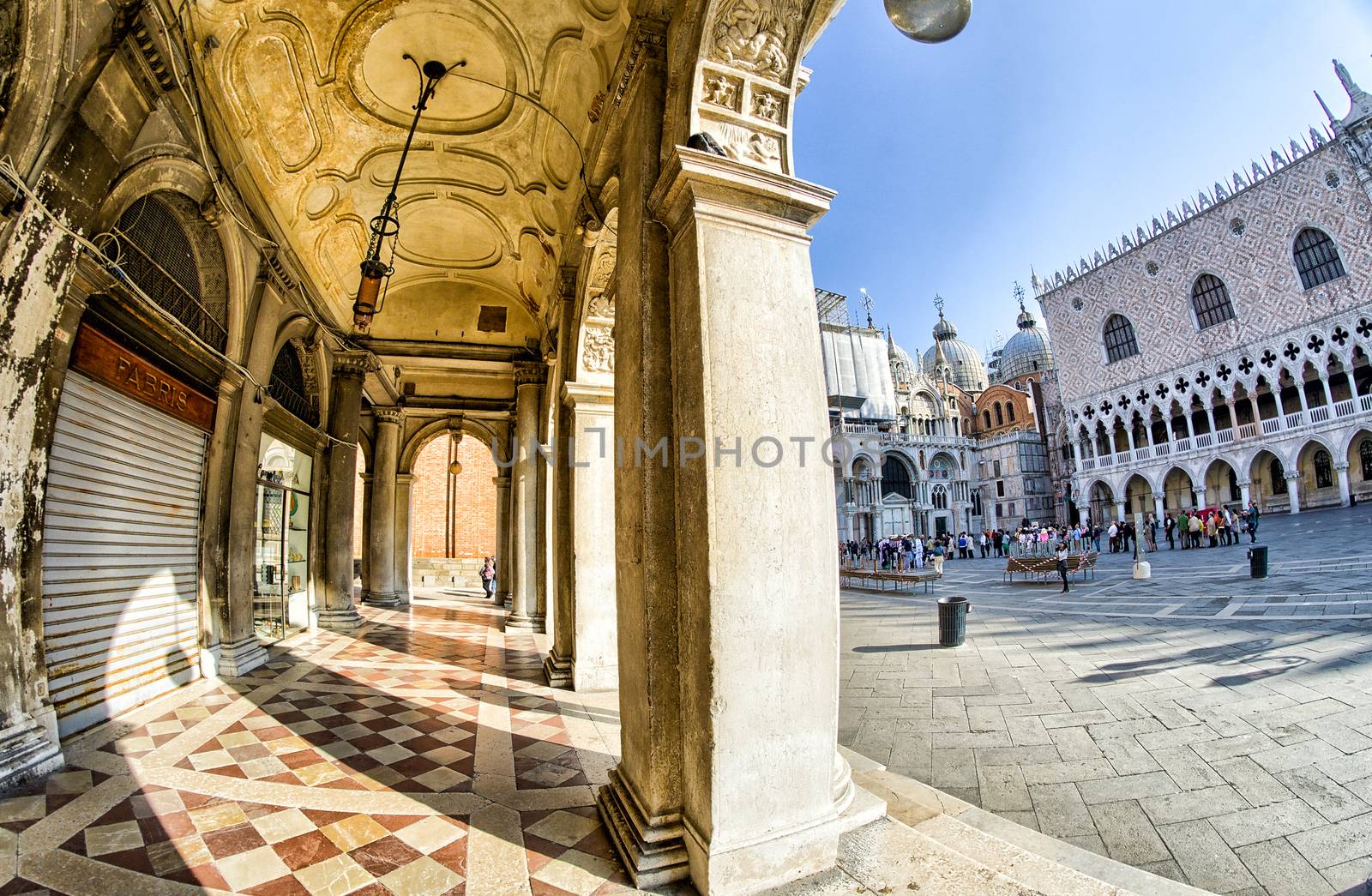 VENICE - APRIL 7, 2014: Tourists enjoy Saint Mark Square on a beautiful spring day. Venice is visted by more than 20 million people every year.