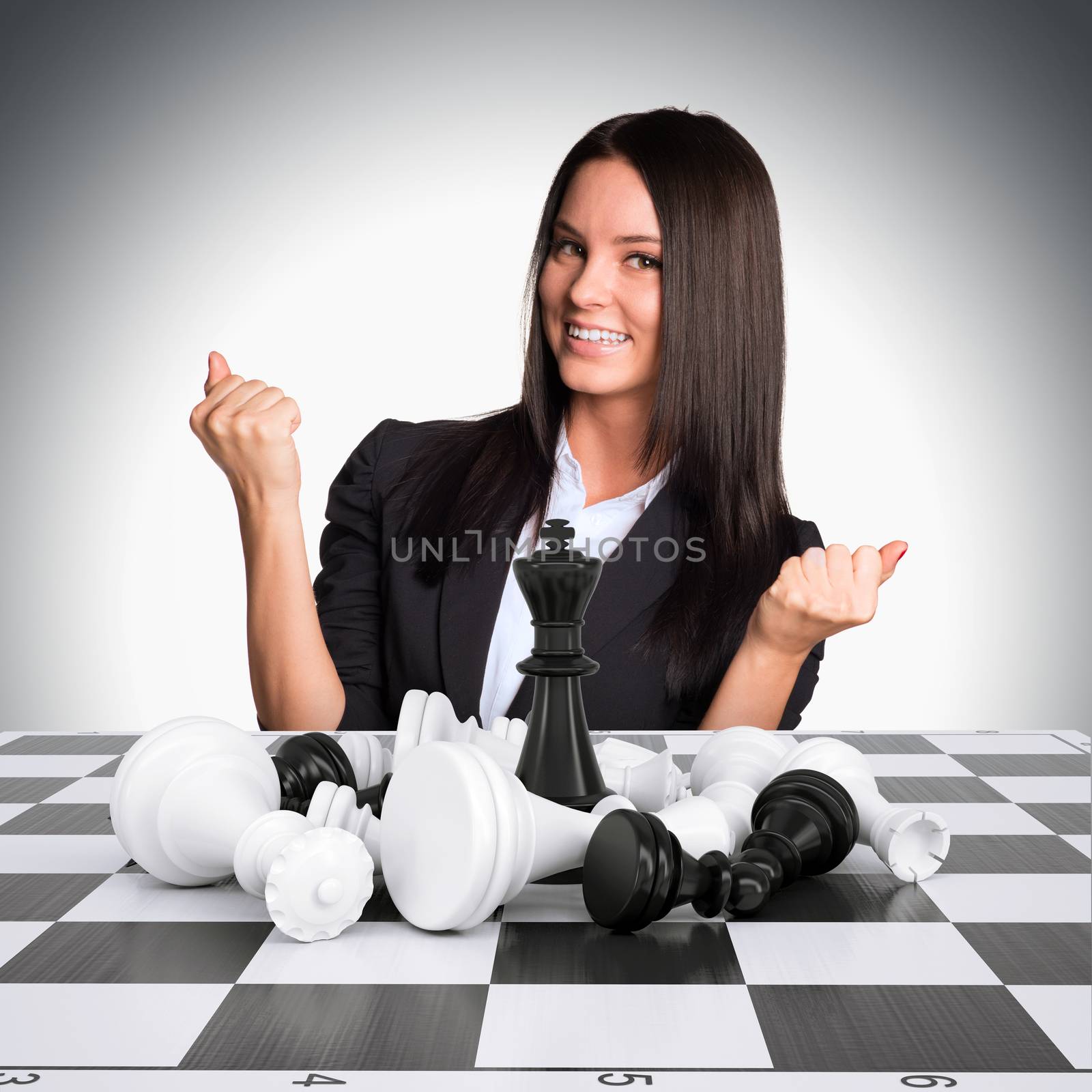 Joyful businesswoman wins chess and raised his hands up by cherezoff
