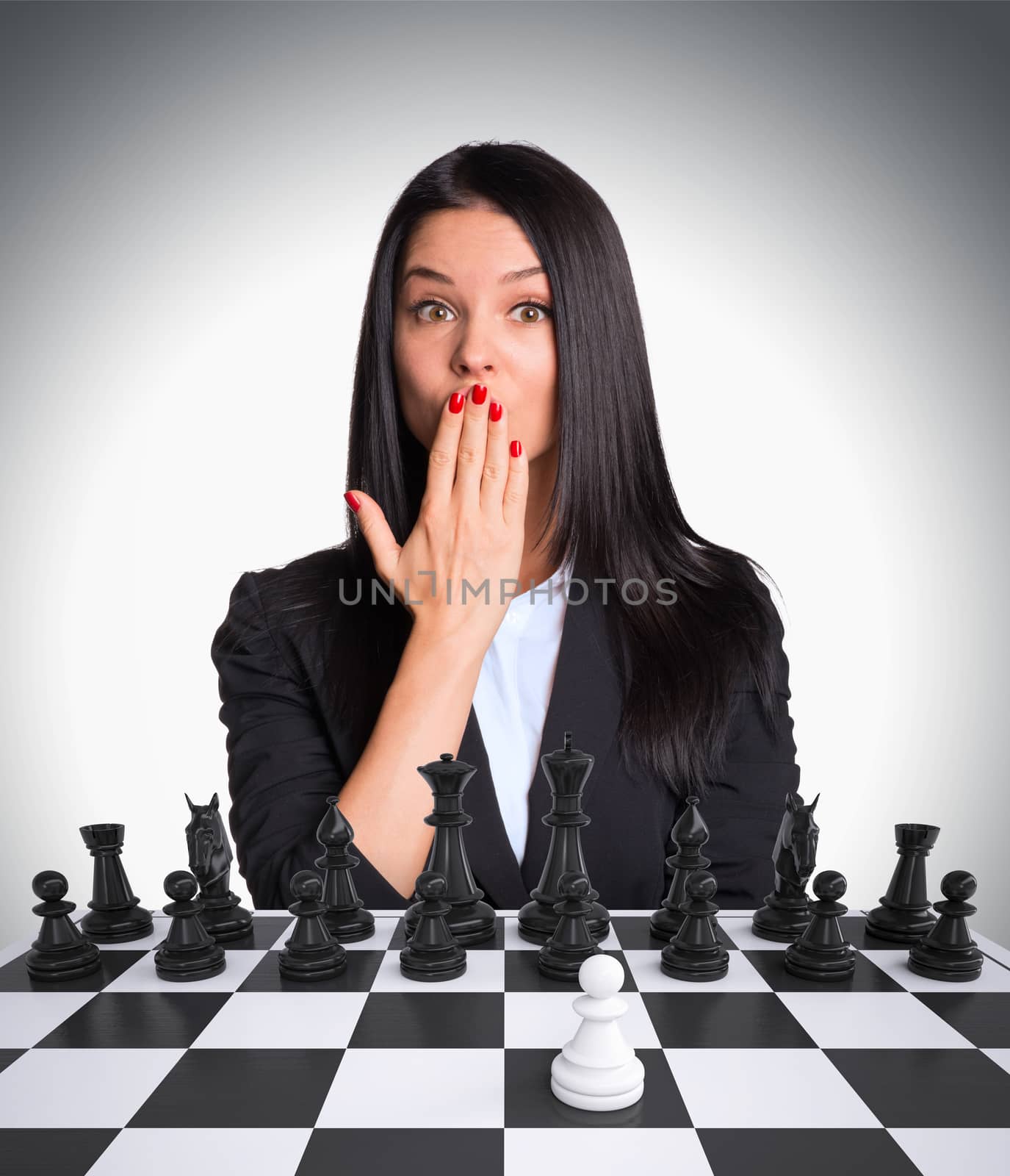 Surprised businesswoman looking at camera. Chessboard with chess by cherezoff