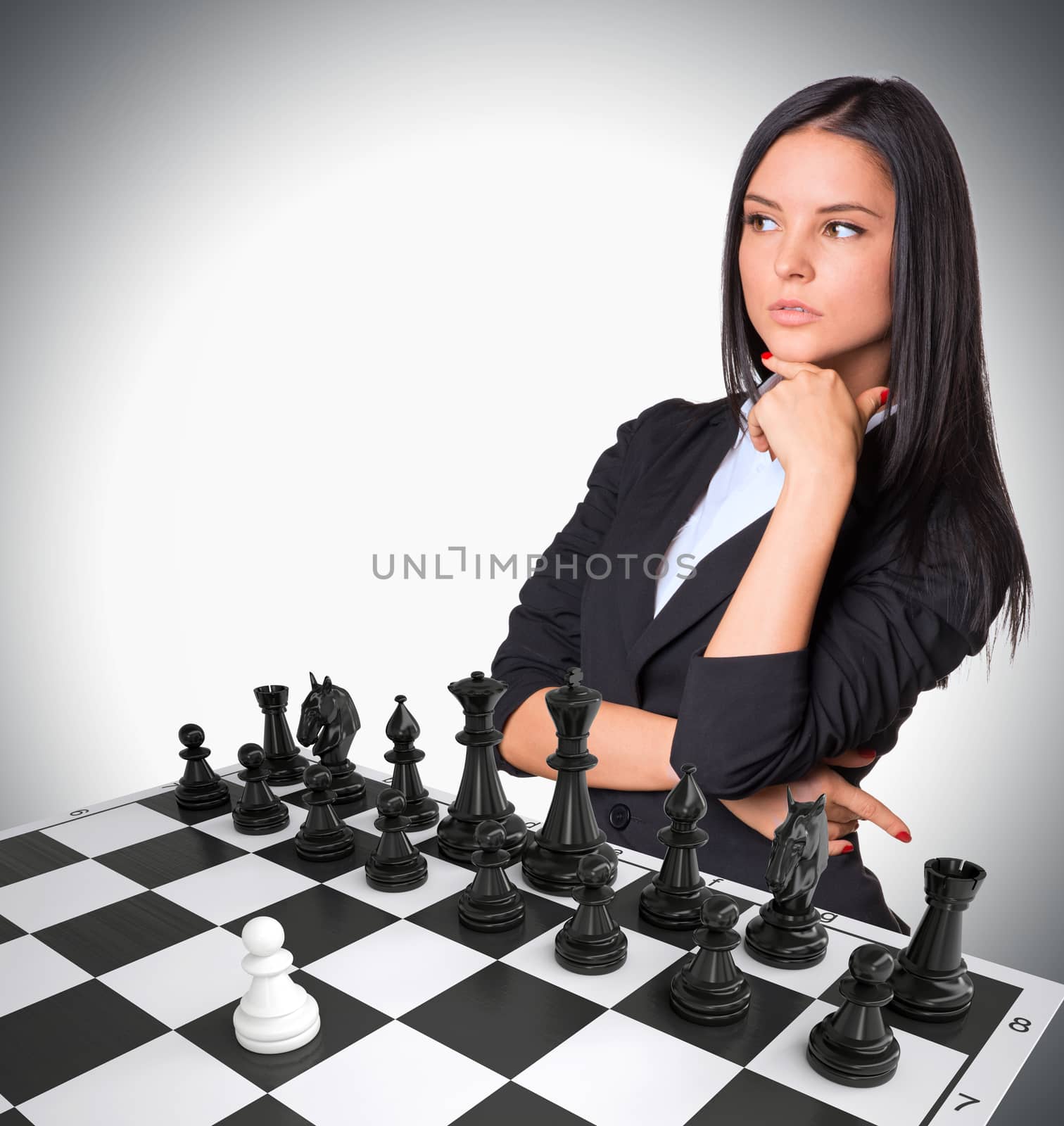 Lost in thought businesswoman looking up. Chessboard with chess. Gray background. Business concept