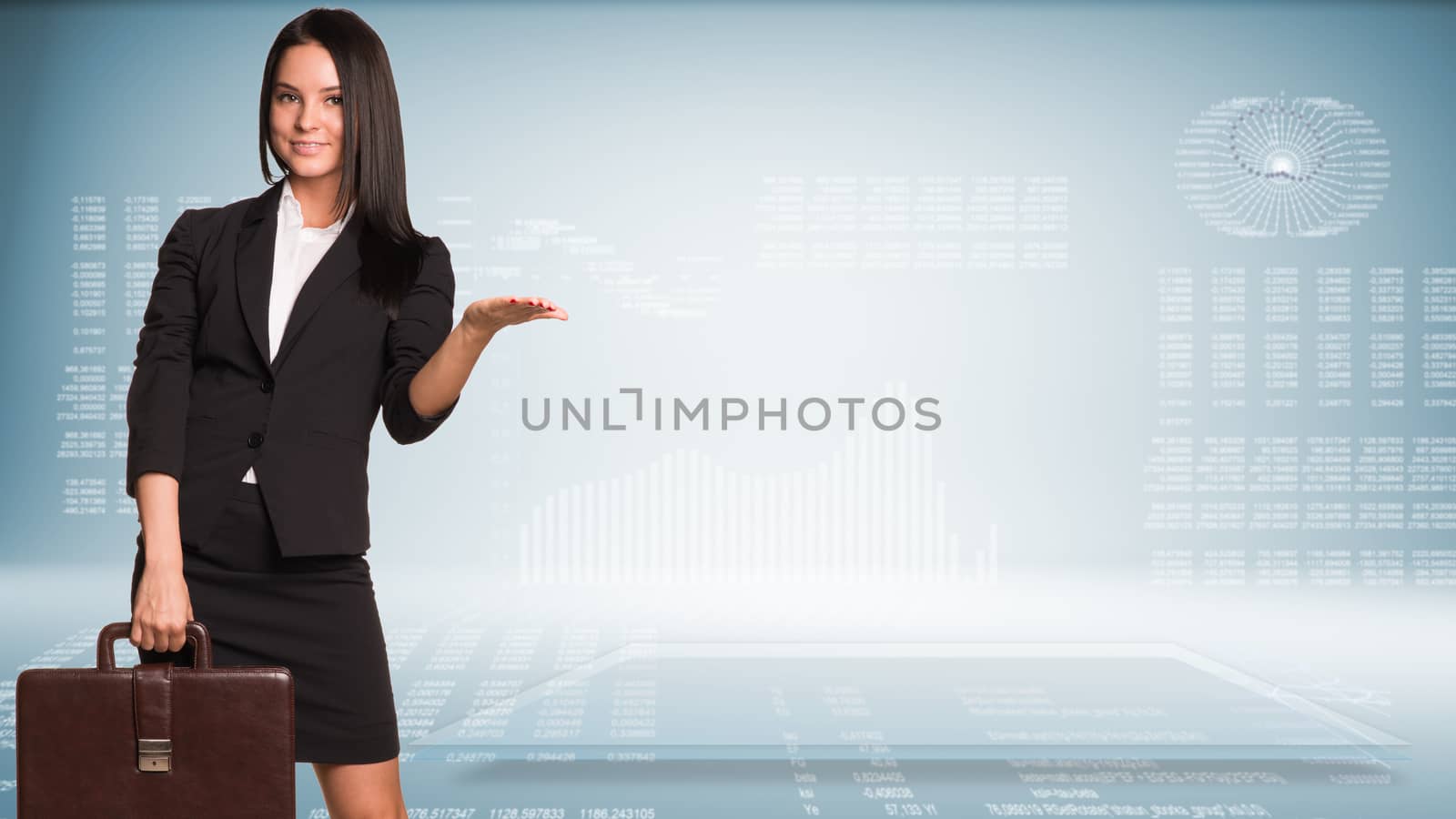 Businesswoman holding briefcase and showing empty palm. High-tech graphs at backdrop