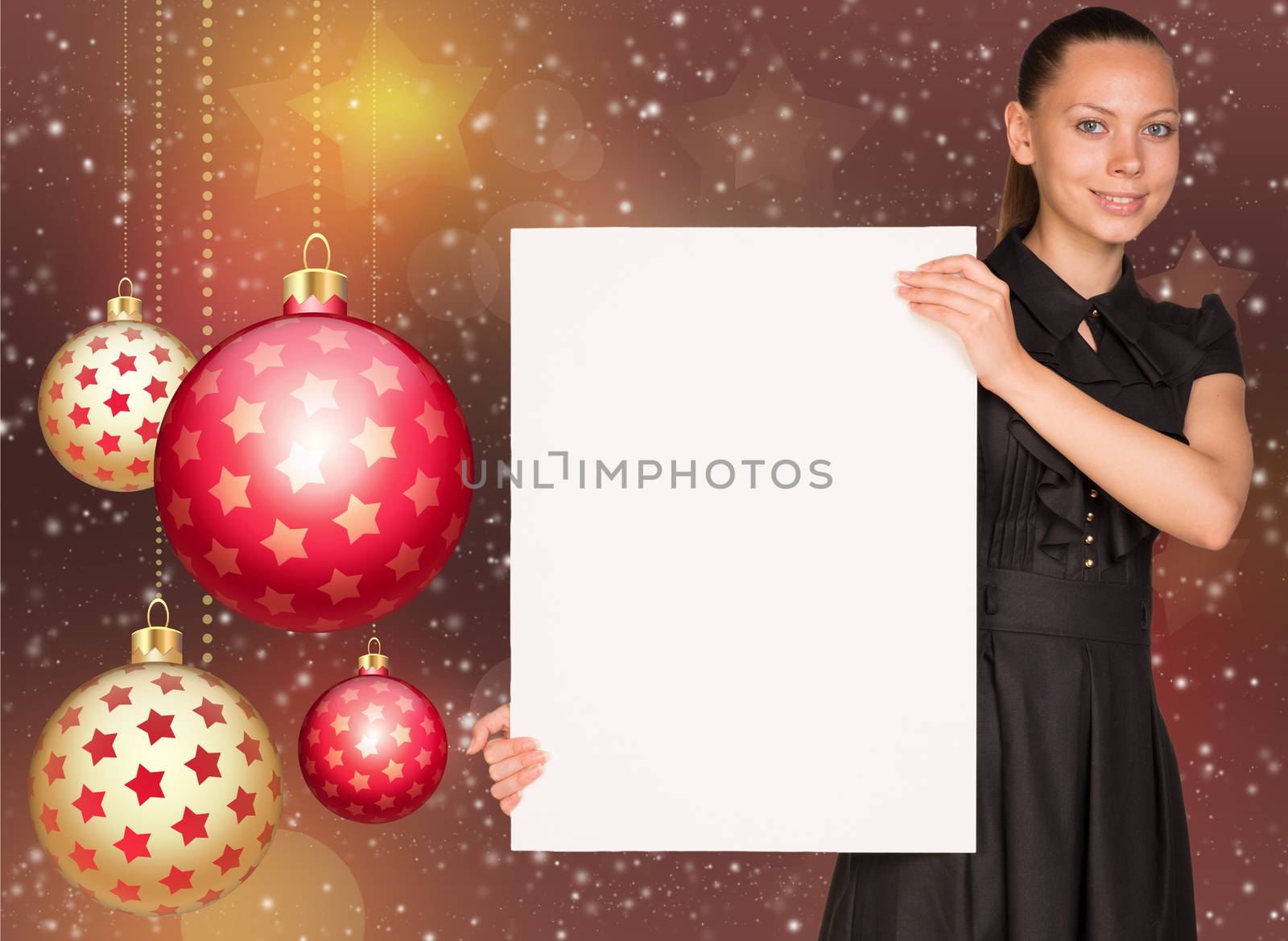 Businesswoman holding empty paper. Christmas tree balls as backdrop