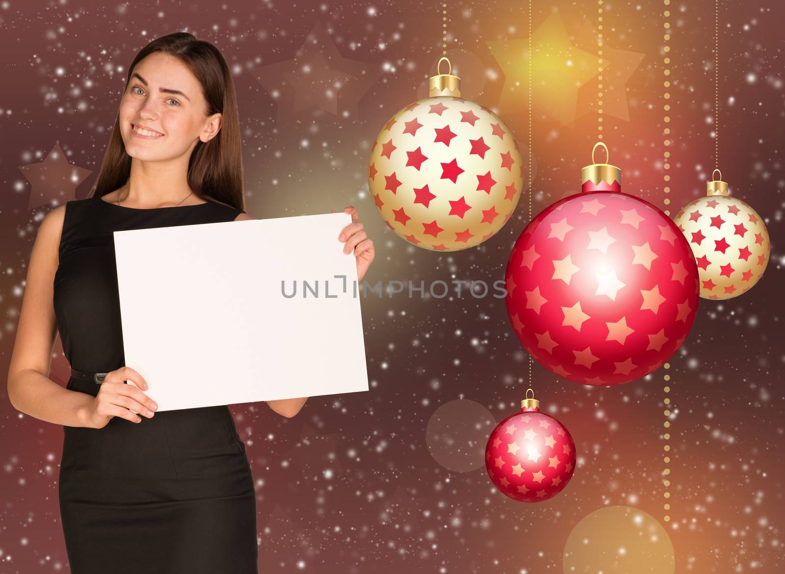 Businesswoman holding empty paper. Christmas tree balls as backdrop