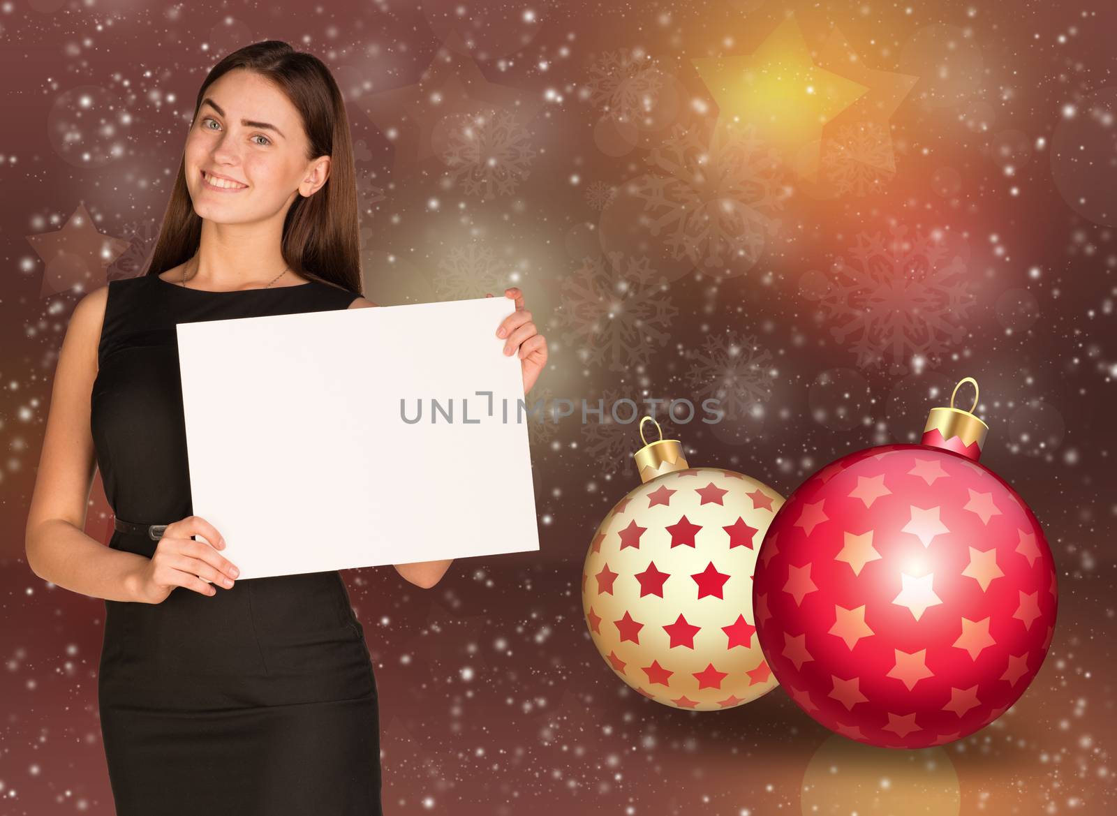 Businesswoman holding empty paper. Christmas tree balls as backdrop