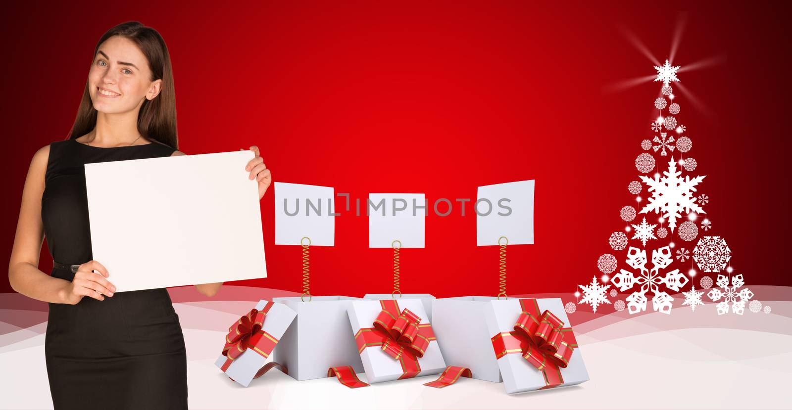 Businesswoman holding empty paper. Christmas tree and gifts as backdrop