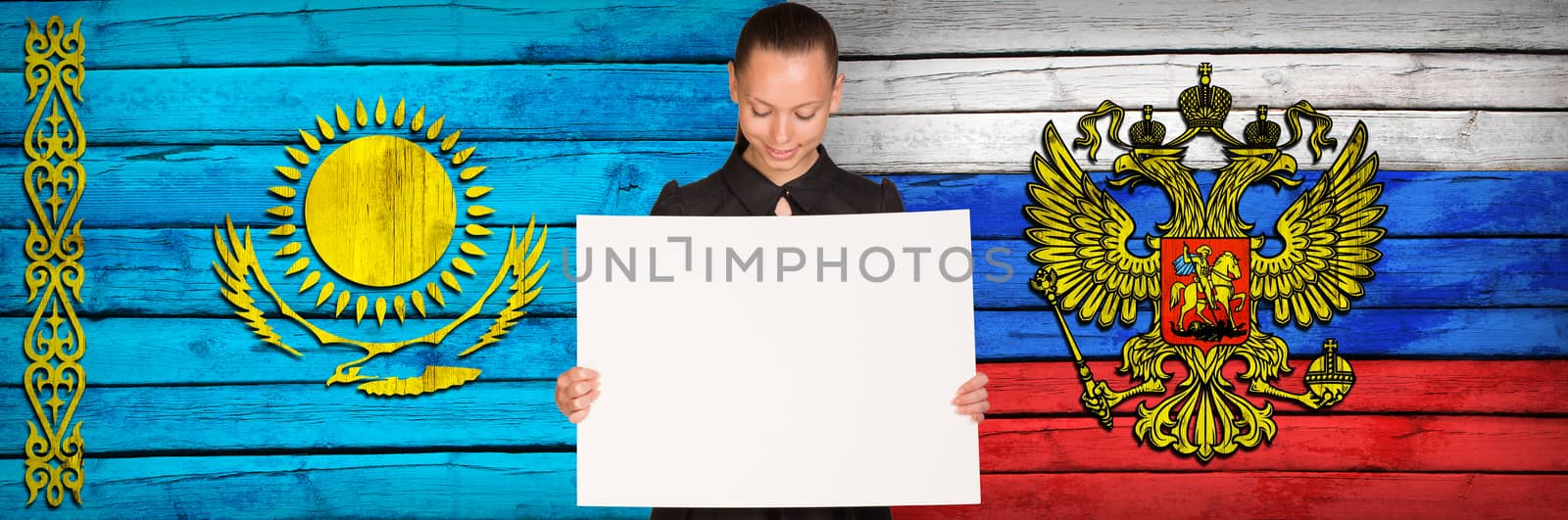 Businesswoman holding paper sheet. Kazakhstan and Russia flags as backdrop