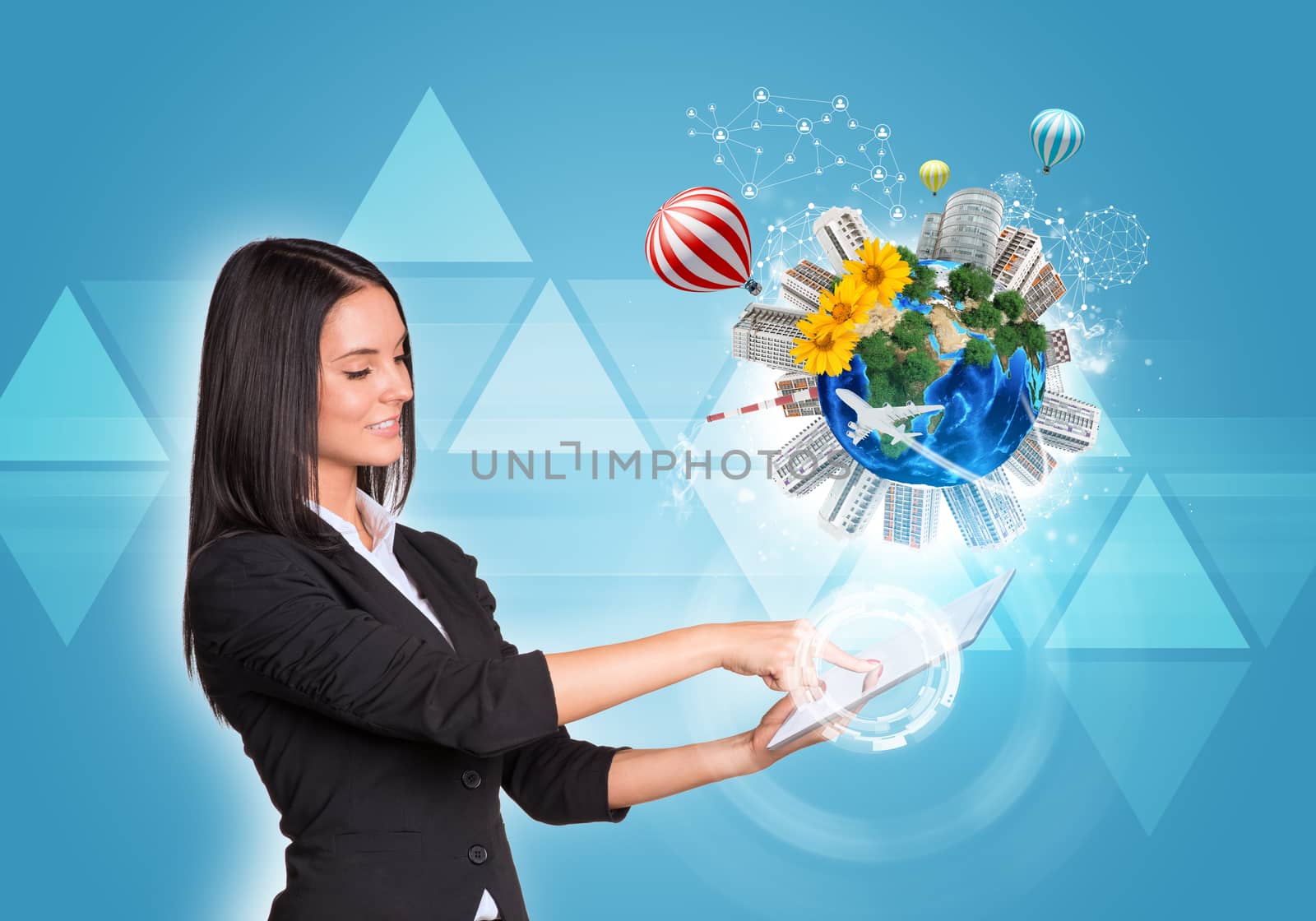 Beautiful businesswomen in suit using digital tablet. Earth with buildings, flowers, airplane and air balloons. Triangles as backdrop. Element of this image furnished by NASA
