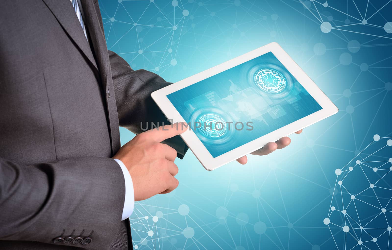 Man hands using tablet pc. Virtual elements on touch screen. Wire-frame spheres as backdrop