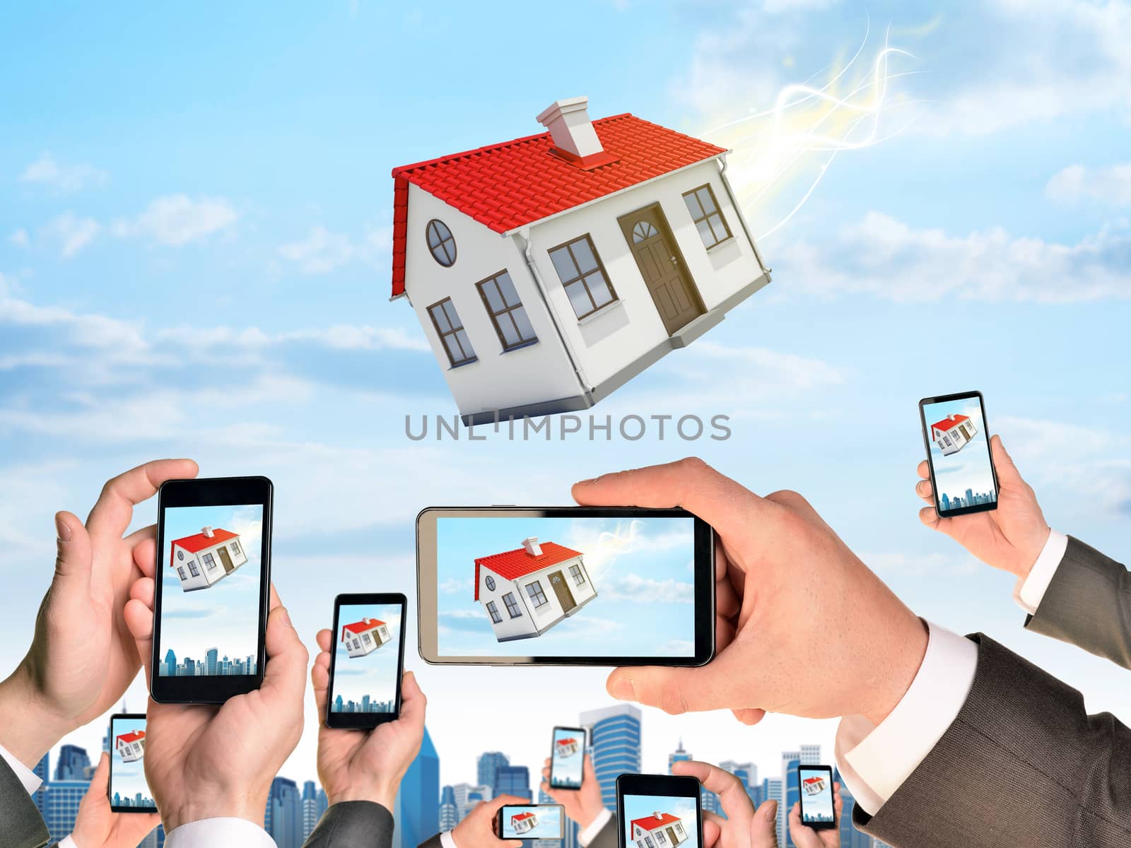 Hands holding smart phones and shoot video as falling house by cherezoff