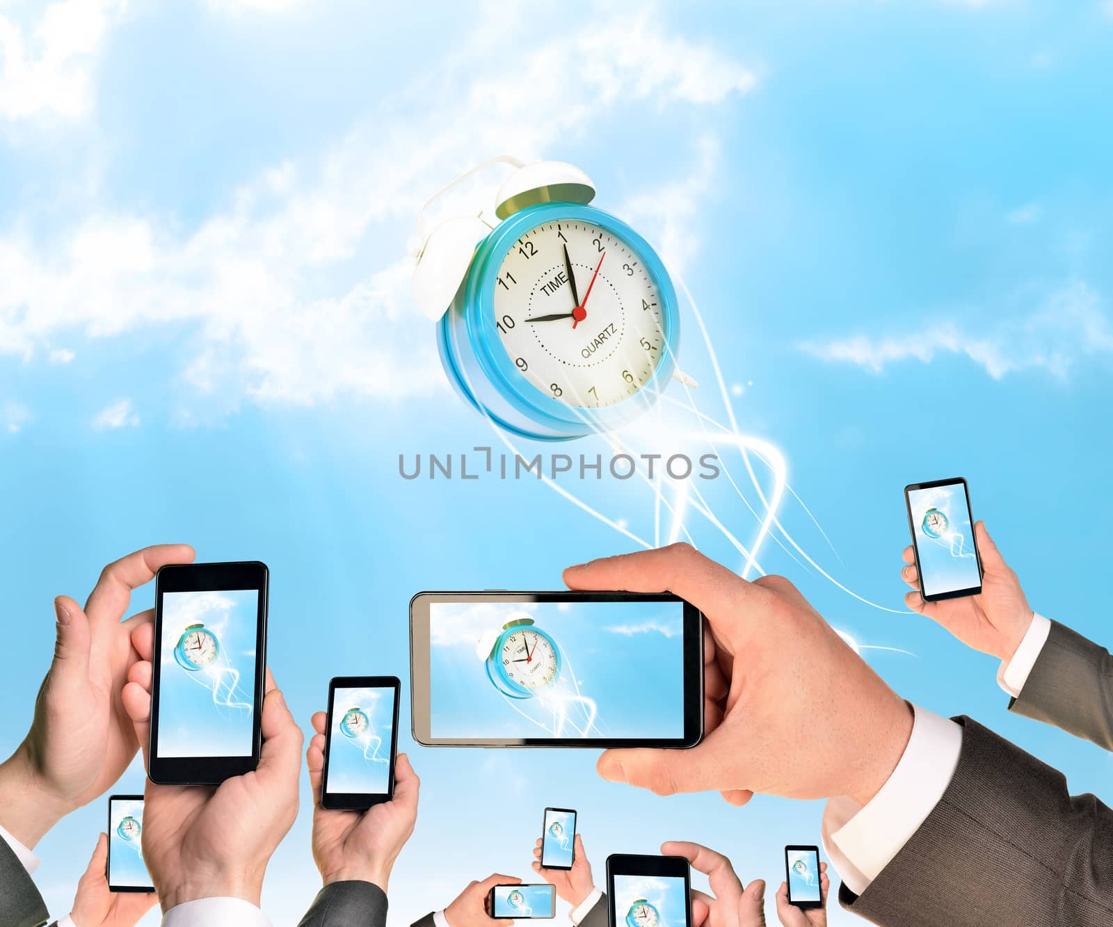 Hands holding smart phones and shoot video as falling alarm clock. Sky with clouds on background