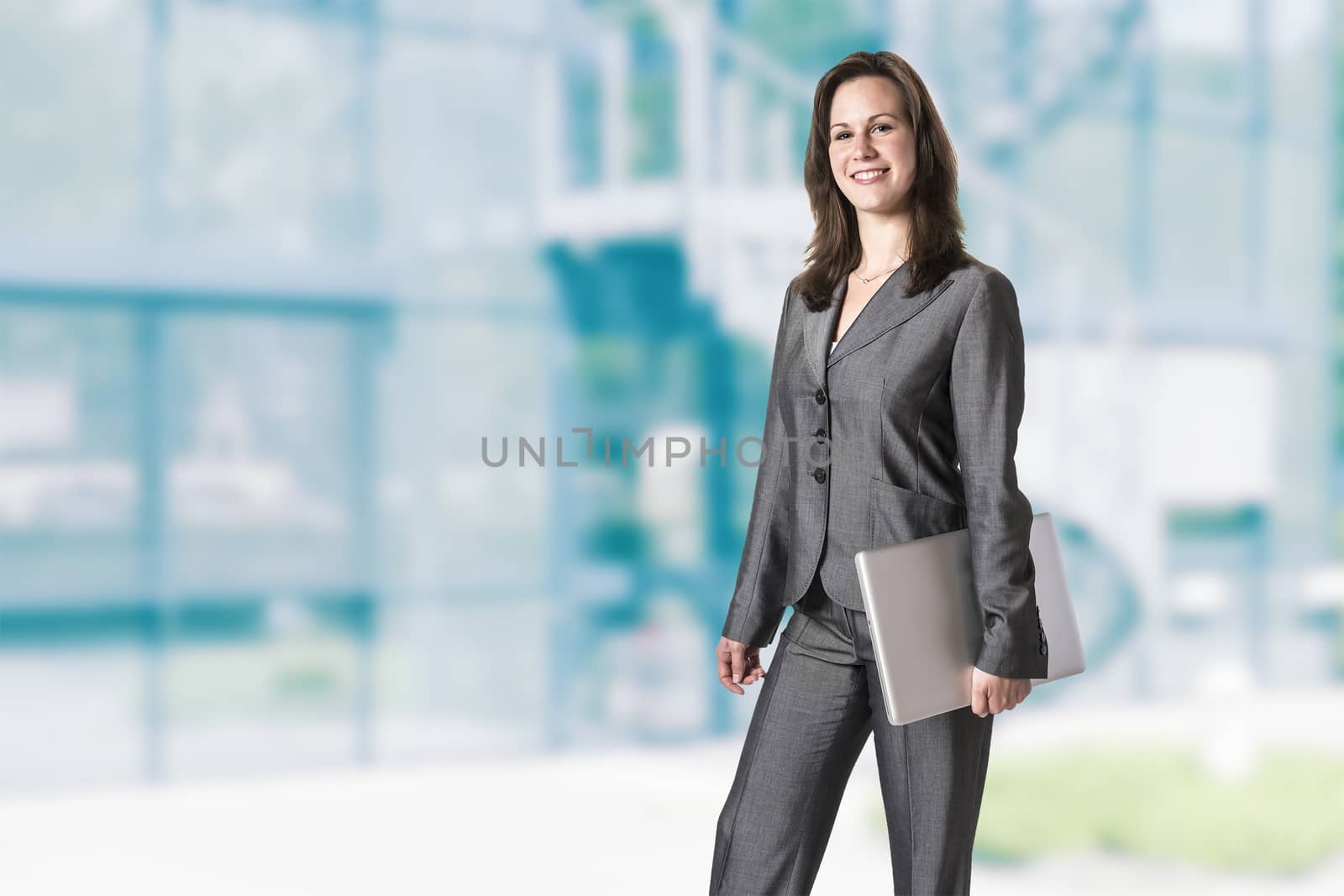 Business woman in gray suit in front of an office building