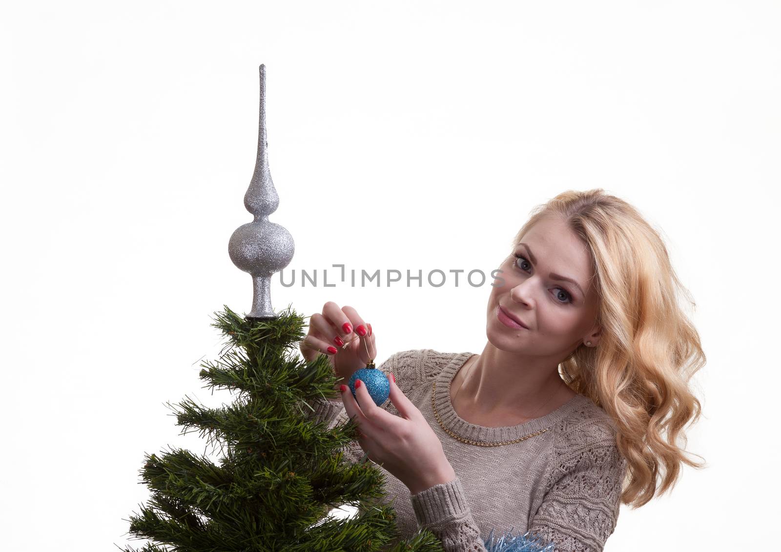 Beautiful girl decorates a Christmas tree by fotooxotnik