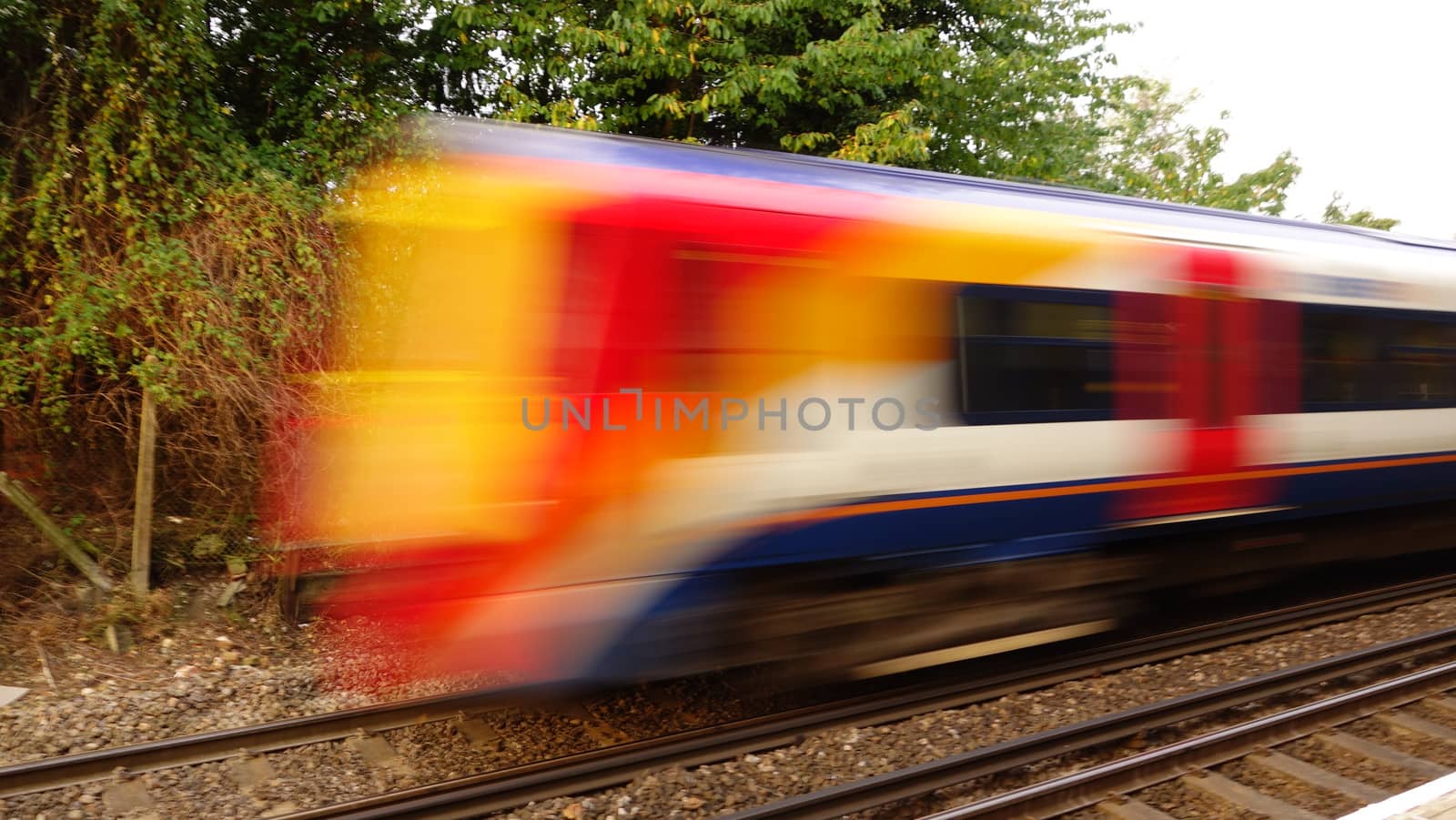 Fast train passing through station, England, UK