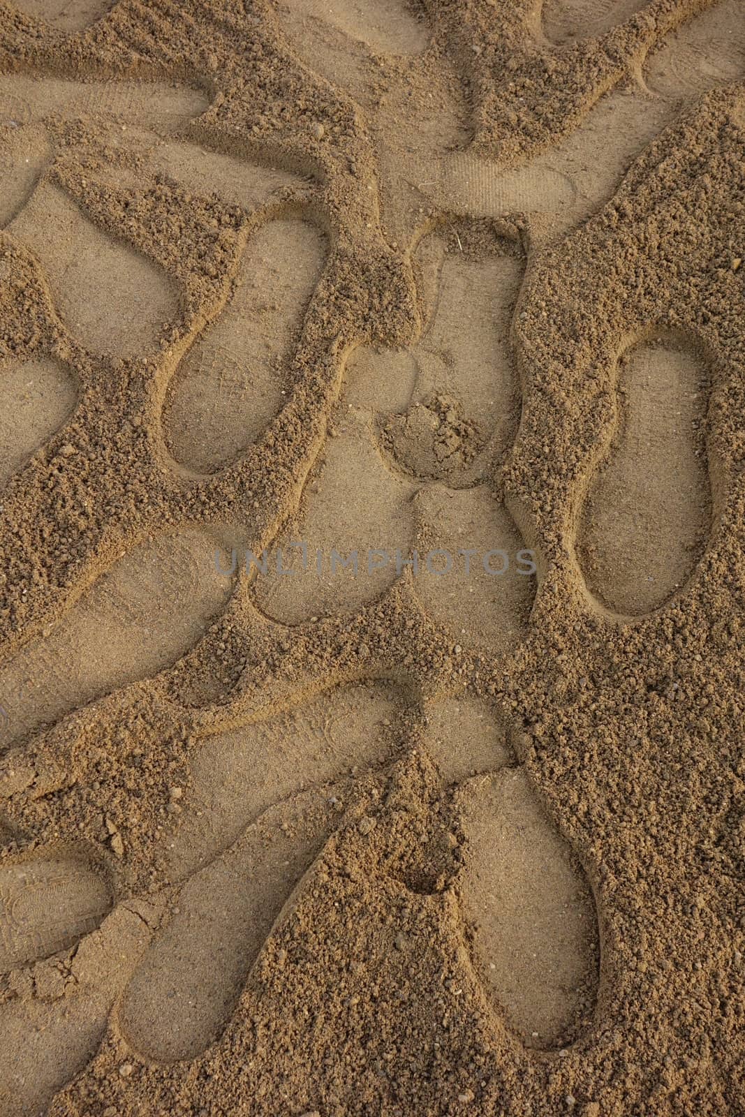 Large shoe foot prints in the sand