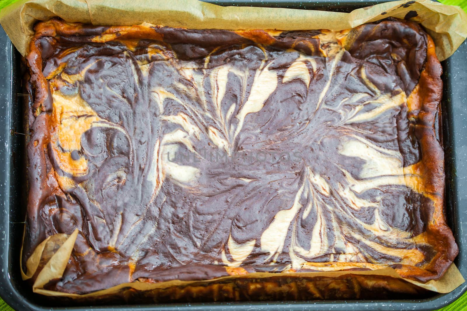 Fresh baked marble cheese cake with chocolate on cooking pan