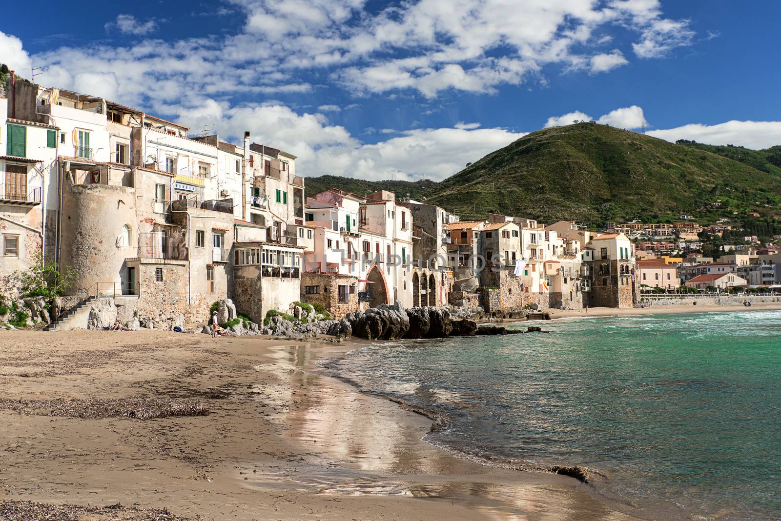 CEFALU, ITALY - APRIL 17, 2014: CEFALU, ITALY - AUGUST 23: Unidentified people at beach in Cefalu, Sicily, Italy. Cefalu is an attractive historic town and seaside resort.