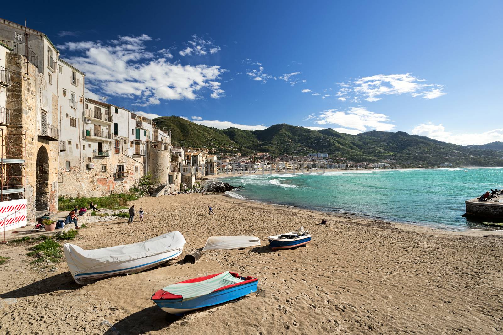 CEFALU, ITALY - APRIL 17, 2014: CEFALU, ITALY - AUGUST 23: Unidentified people at beach in Cefalu, Sicily, Italy. Cefalu is an attractive historic town and seaside resort.