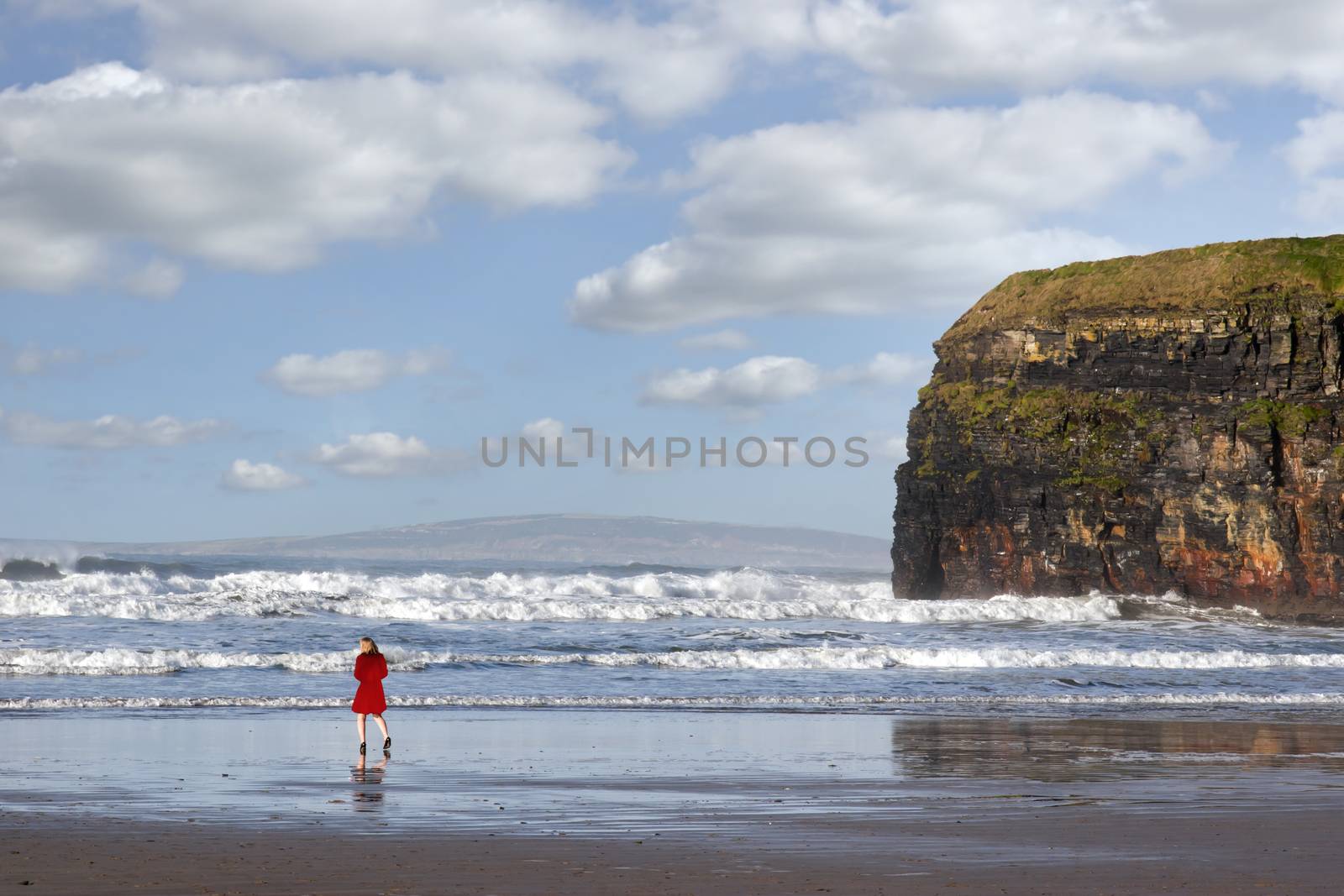 lady in red with high heels on beach by morrbyte