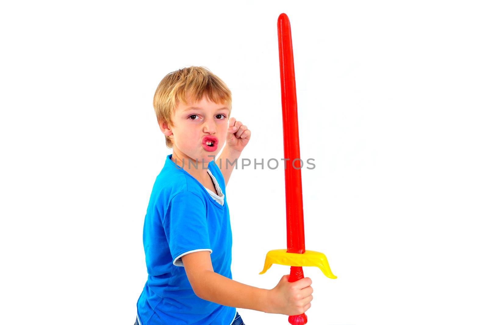 Young boy in studio playing with sword on white background by seawaters