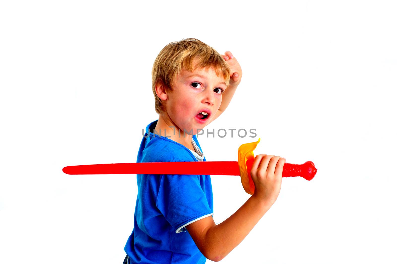 Young boy in studio playing with sword on white background by seawaters