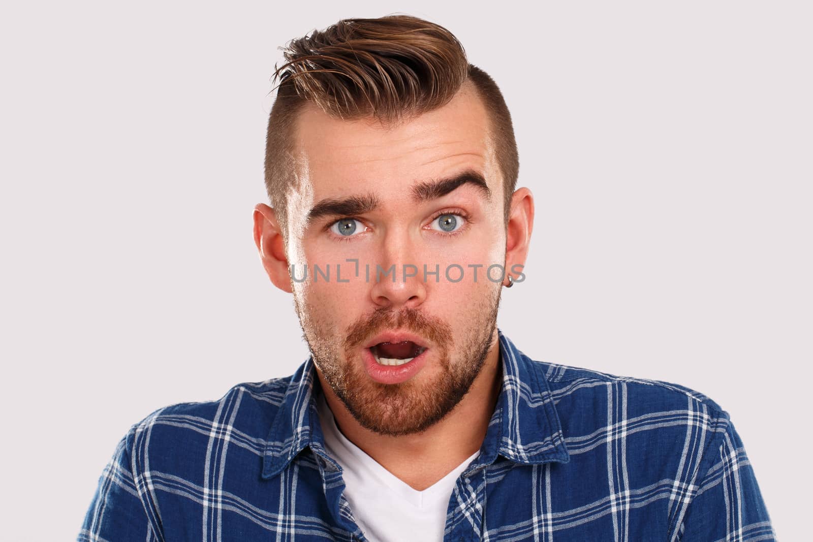 Emotions, feelings. Young guy with on a white background