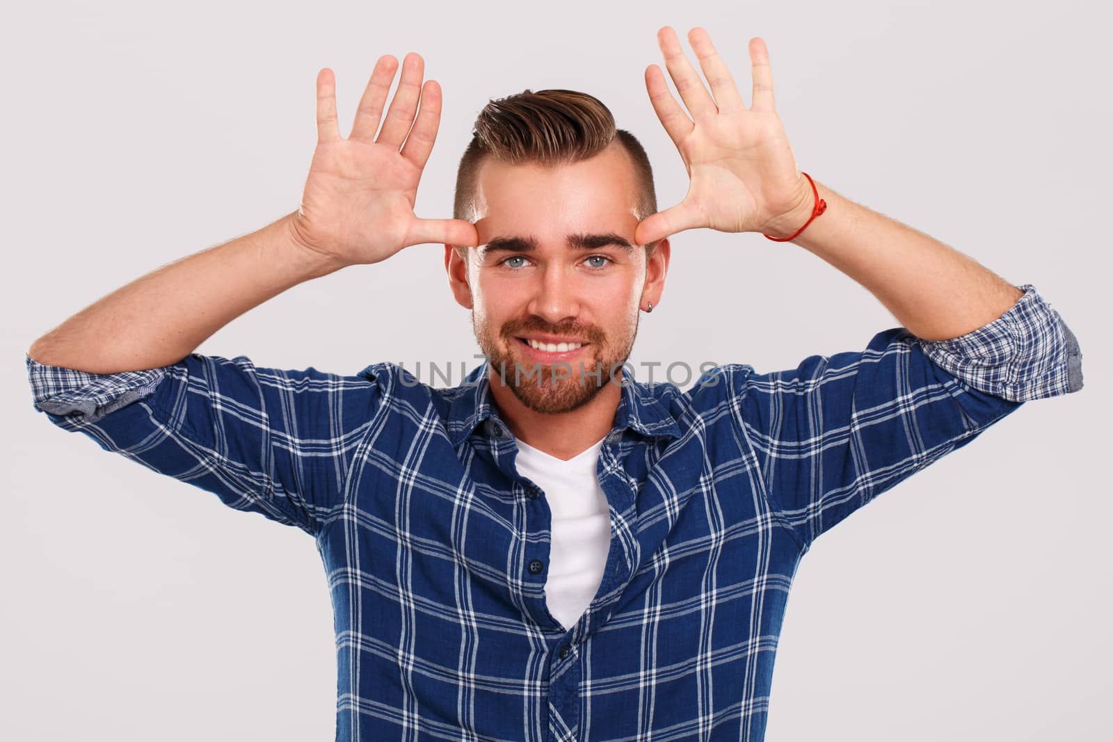 Emotions, feelings. Young guy with on a white background