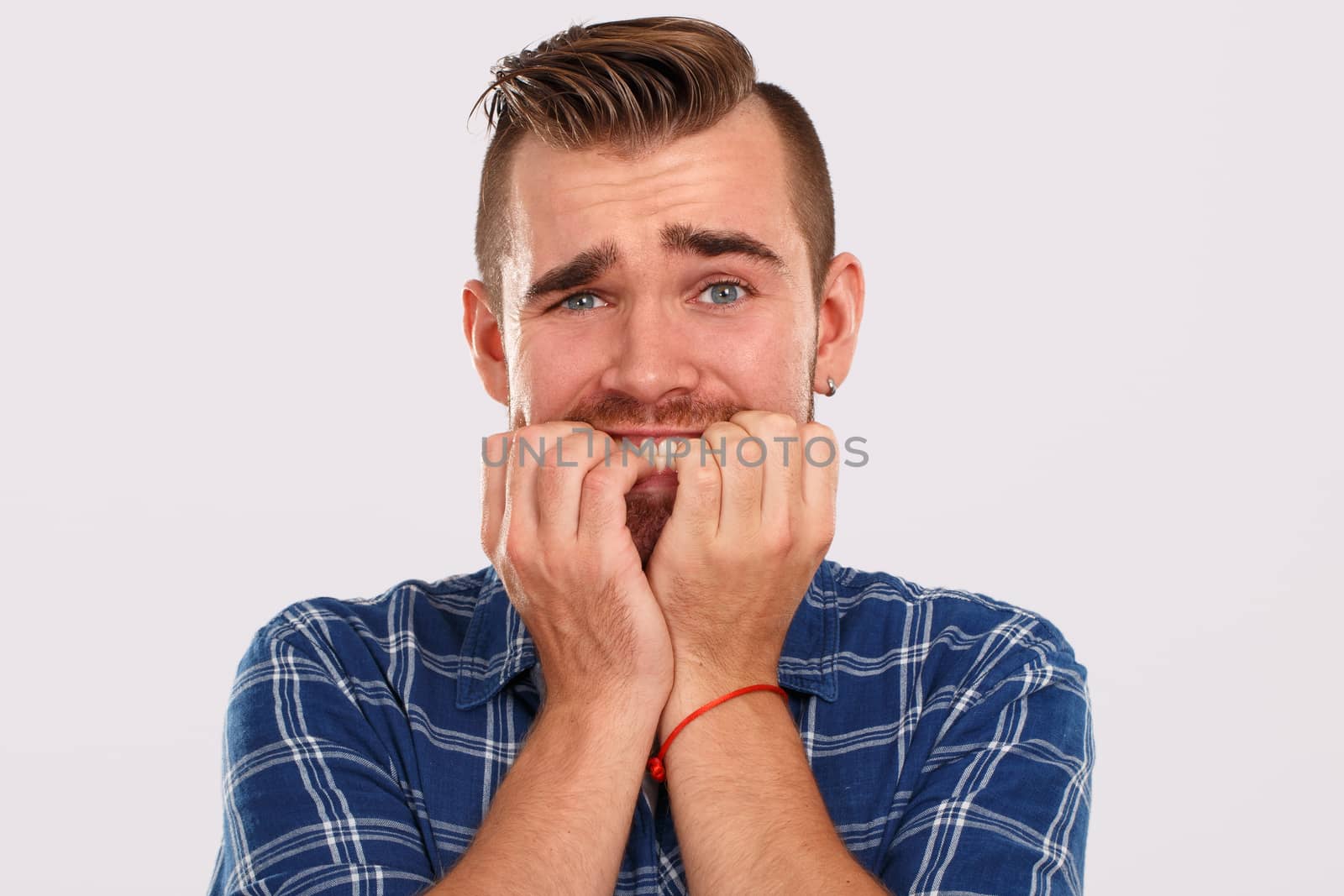 Emotions, feelings. Young guy with on a white background