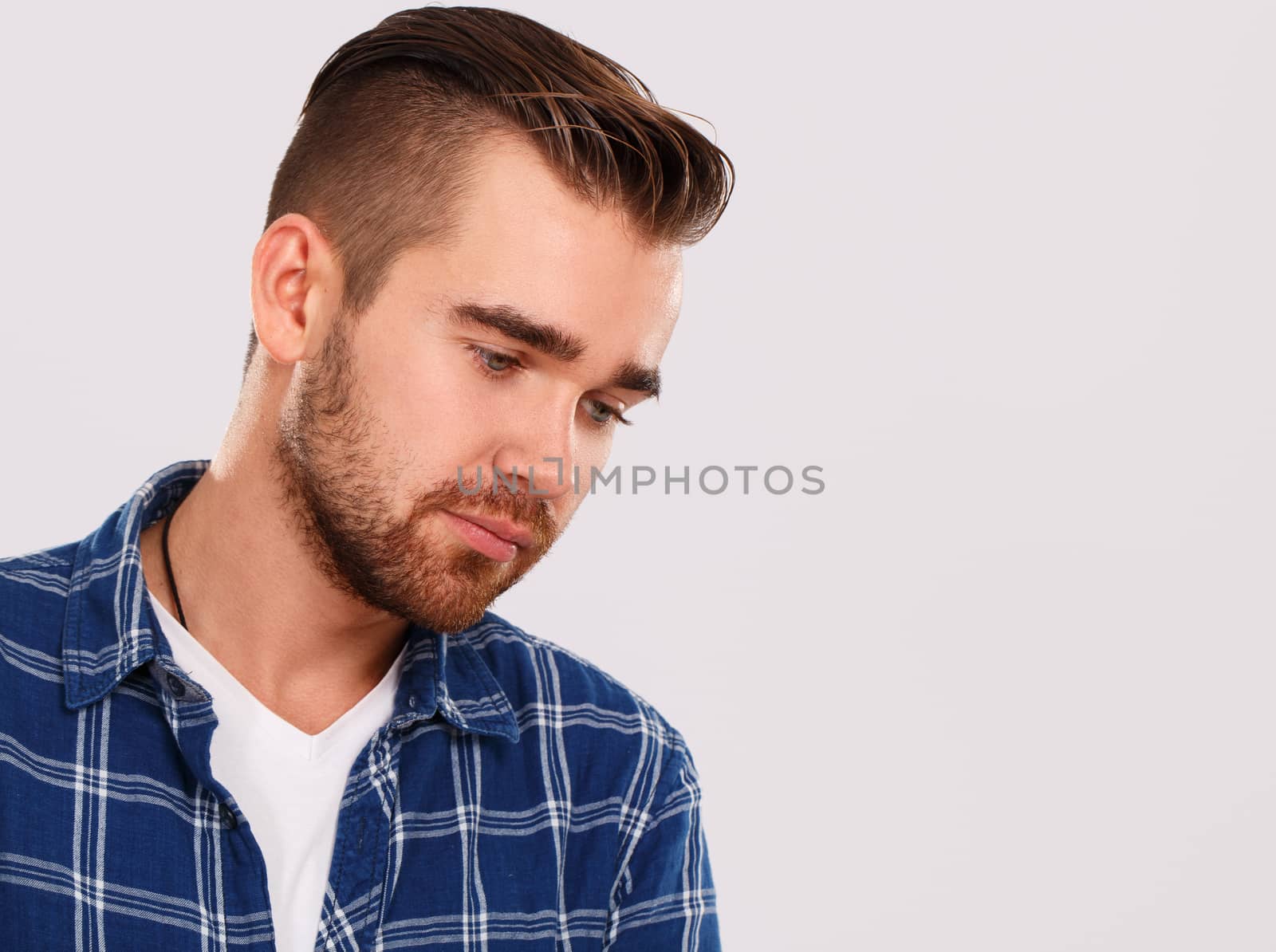 Emotions, feelings. Young guy with on a white background