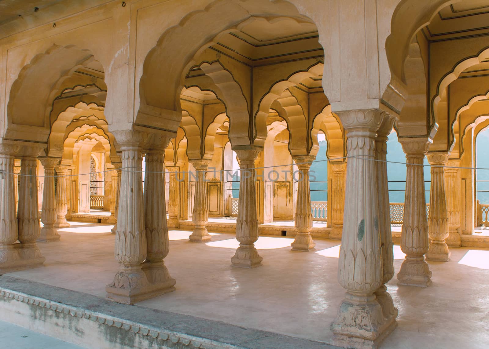 Gallery of rimmed pillars in light sunshine at Jaipur's Amber Fo by Claudine