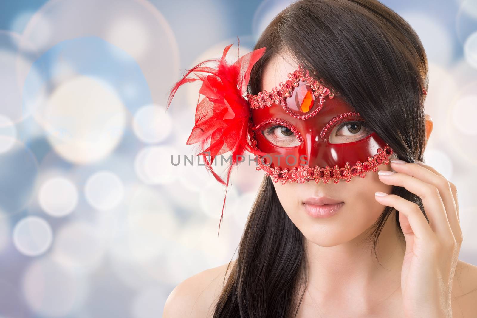 Portrait of Asian young beautiful woman in a carnival mask, closeup portrait.