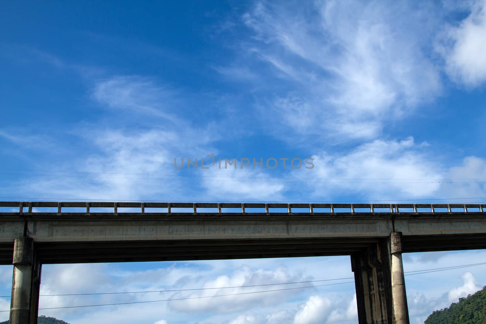 bridge across river with mountain blue sky