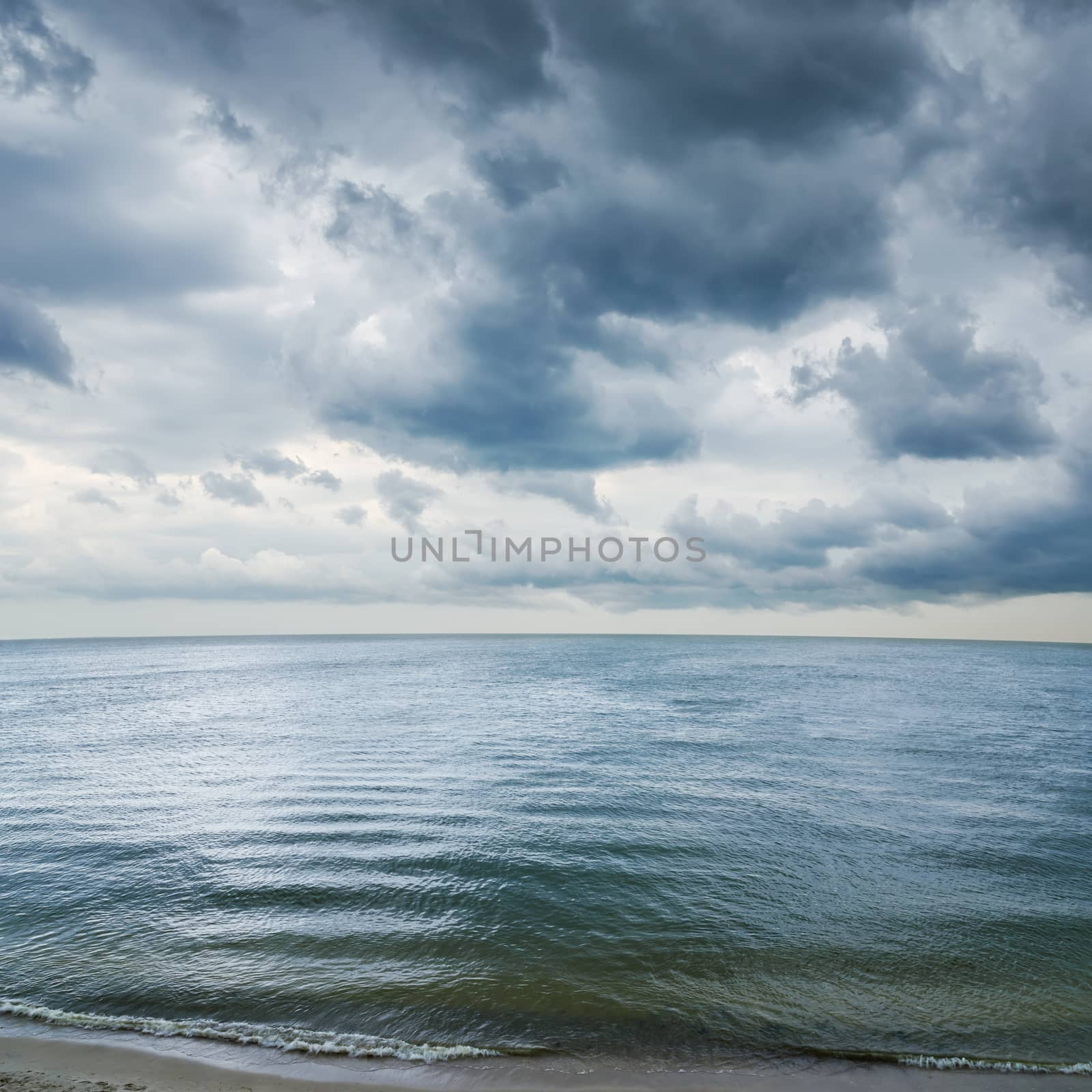 low dramatic clouds over dark water