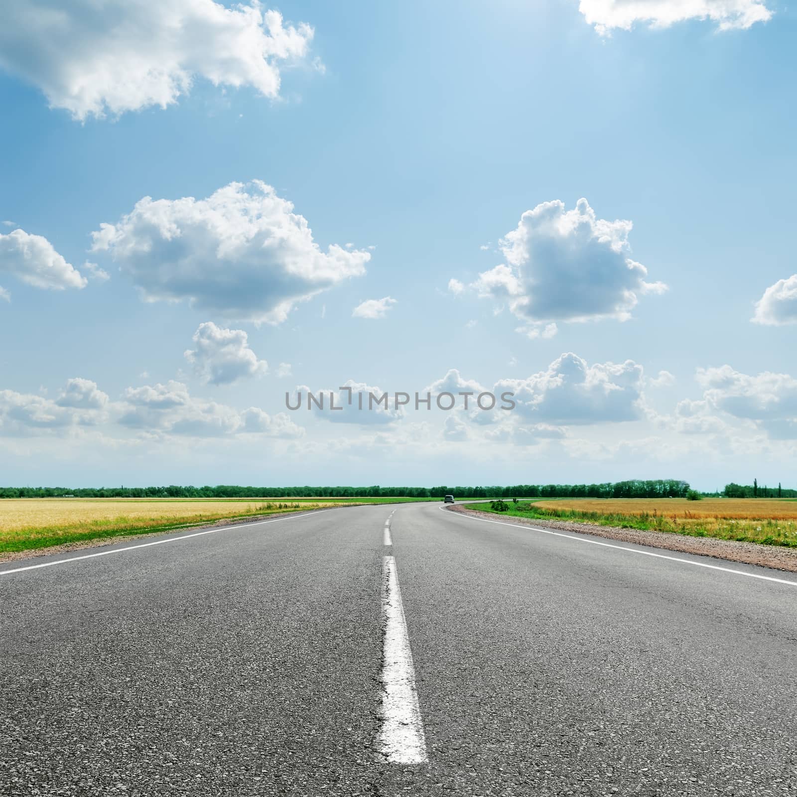 asphalt road with white line to cloudy horizon